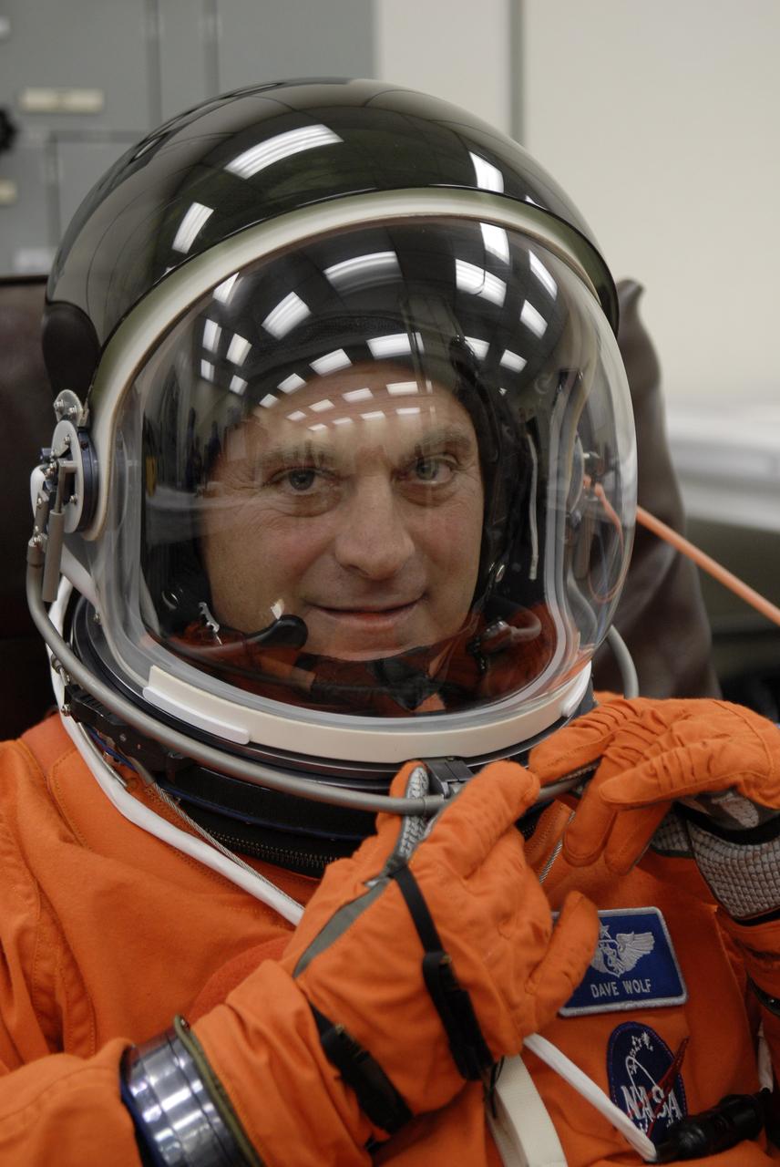 CAPE CANAVERAL, Fla. – In the Operations and Checkout Building at NASA's Kennedy Space Center in Florida, STS-127 crew members put on their launch-and-entry suits before heading to the Astrovan for the 3.4-mile drive to Launch Pad 39A. Seen here is Mission Specialist Dave Wolf, who is checking his helmet. At the pad, Wolf and the other crew members will complete their suitup and enter space shuttle Endeavour for the 7:13 p.m. EDT liftoff. This is the fourth launch attempt for the STS-127 mission. The first two launch attempts on June 13 and June 17 were scrubbed when a hydrogen gas leak occurred during tanking due to a misaligned Ground Umbilical Carrier Plate. Mission managers also decided to delay tanking on July 11 for a launch attempt later in the day to allow engineers and safety personnel time to analyze data captured during lightning strikes near the pad on July 10. Endeavour will deliver the Japanese Experiment Module's Exposed Facility, or JEM-EF, and the Experiment Logistics Module-Exposed Section, or ELM-ES, in the final of three flights dedicated to the assembly of the Japan Aerospace Exploration Agency's Kibo laboratory complex on the International Space Station. STS-127 is the 29th flight for the assembly of the space station. Photo credit: NASA/Kim Shiflett