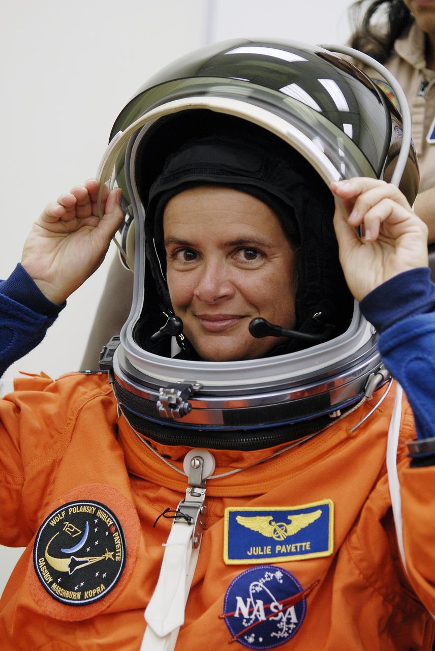 CAPE CANAVERAL, Fla. – In the Operations and Checkout Building at NASA's Kennedy Space Center in Florida, STS-127 crew members put on their launch-and-entry suits before heading to the Astrovan for the 3.4-mile drive to Launch Pad 39A.  Seen here, Mission Specialist Julie Payette of the Canadian Space Agency adjusts her helmet. At the pad, Payette and the other crew members will complete their suitup and enter space shuttle Endeavour for the 7:13 p.m. EDT liftoff.  This is the fourth launch attempt for the STS-127 mission. The first two launch attempts on June 13 and June 17 were scrubbed when a hydrogen gas leak occurred during tanking due to a misaligned Ground Umbilical Carrier Plate. Mission managers also decided to delay tanking on July 11 for a launch attempt later in the day to allow engineers and safety personnel time to analyze data captured during lightning strikes near the pad on July 10. Endeavour will deliver the Japanese Experiment Module's Exposed Facility, or JEM-EF, and the Experiment Logistics Module-Exposed Section, or ELM-ES, in the final of three flights dedicated to the assembly of the Japan Aerospace Exploration Agency's Kibo laboratory complex on the International Space Station.  STS-127 is the 29th flight for the assembly of the space station.   Photo credit: NASA/Kim Shiflett