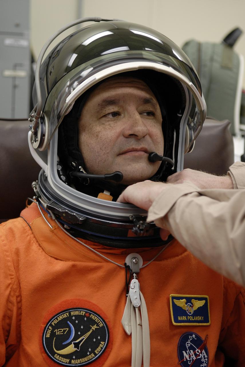 CAPE CANAVERAL, Fla. – In the Operations and Checkout Building at NASA's Kennedy Space Center in Florida, STS-127 crew members put on their launch-and-entry suits before heading to the Astrovan for the 3.4-mile drive to Launch Pad 39A. Here, Commander Mark Polansky is helped with the fit of his helmet. At the pad, Polansky and other crew members will complete their suitup and enter space shuttle Endeavour for the 7:13 p.m. EDT liftoff. This is the fourth launch attempt for the STS-127 mission. The first two launch attempts on June 13 and June 17 were scrubbed when a hydrogen gas leak occurred during tanking due to a misaligned Ground Umbilical Carrier Plate. Mission managers also decided to delay tanking on July 11 for a launch attempt later in the day to allow engineers and safety personnel time to analyze data captured during lightning strikes near the pad on July 10. Endeavour will deliver the Japanese Experiment Module's Exposed Facility, or JEM-EF, and the Experiment Logistics Module-Exposed Section, or ELM-ES, in the final of three flights dedicated to the assembly of the Japan Aerospace Exploration Agency's Kibo laboratory complex on the International Space Station. STS-127 is the 29th flight for the assembly of the space station. Photo credit: NASA/Kim Shiflett
