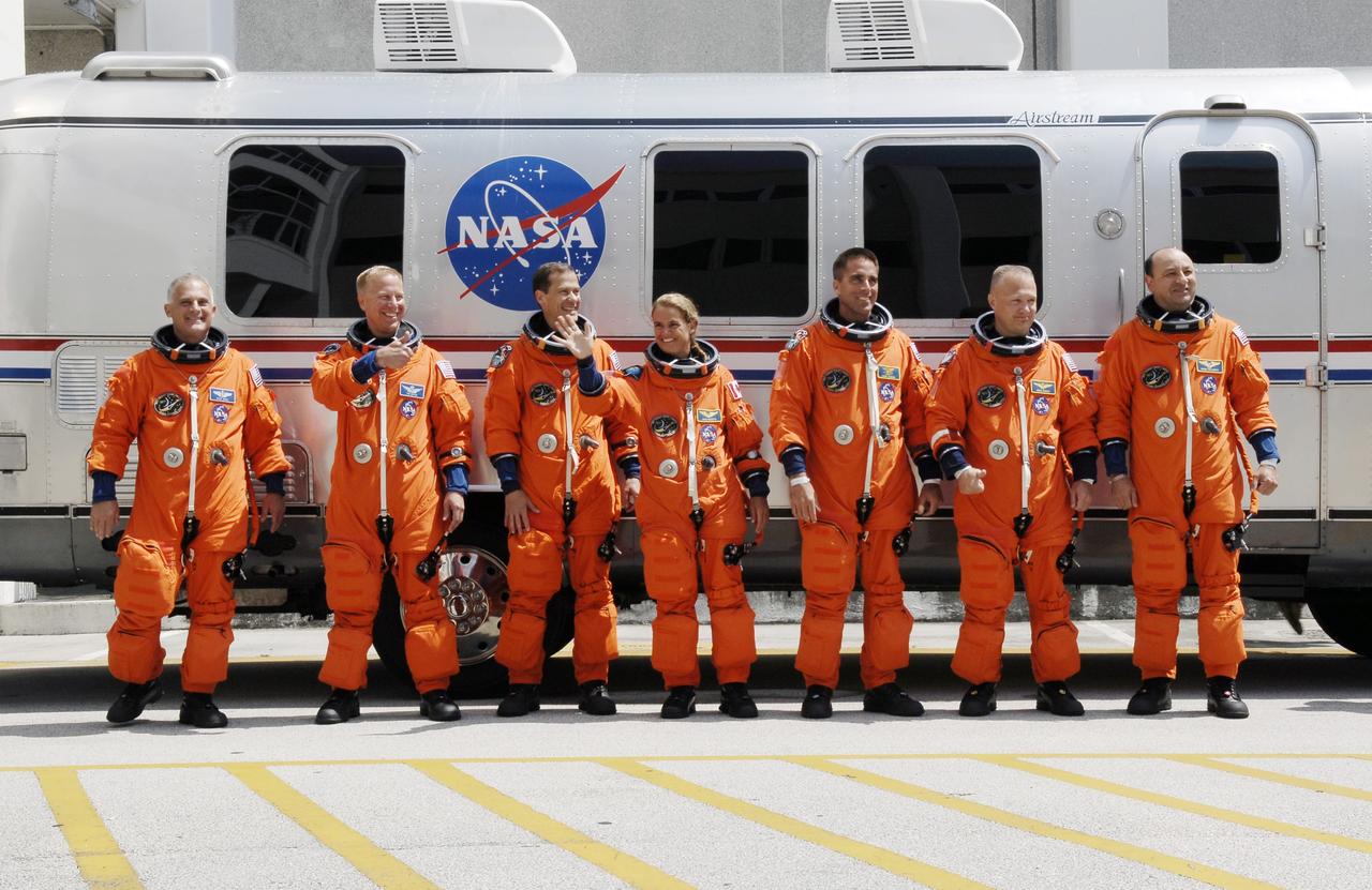 CAPE CANAVERAL, Fla. – The STS-127 crew members pause to wave to spectators as they head head to the Astrovan for the 3.4-mile drive to Launch Pad 39A. From left are Mission Specialists Dave Wolf, Tim Kopra, Tom Marshburn, Julie Payette of the Canadian Space Agency, and Christopher Cassidy, Pilot Doug Hurley and Commander Mark Polansky. At the pad, the astronauts will complete their suitup and enter space shuttle Endeavour for the 7:13 p.m. EDT liftoff.  This is the fourth launch attempt for the STS-127 mission. The first two launch attempts on June 13 and June 17 were scrubbed when a hydrogen gas leak occurred during tanking due to a misaligned Ground Umbilical Carrier Plate. Mission managers also decided to delay tanking on July 11 for a launch attempt later in the day to allow engineers and safety personnel time to analyze data captured during lightning strikes near the pad on July 10. Endeavour will deliver the Japanese Experiment Module's Exposed Facility, or JEM-EF, and the Experiment Logistics Module-Exposed Section, or ELM-ES, in the final of three flights dedicated to the assembly of the Japan Aerospace Exploration Agency's Kibo laboratory complex on the International Space Station.  STS-127 is the 29th flight for the assembly of the space station.   Photo credit: NASA/Kim Shiflett