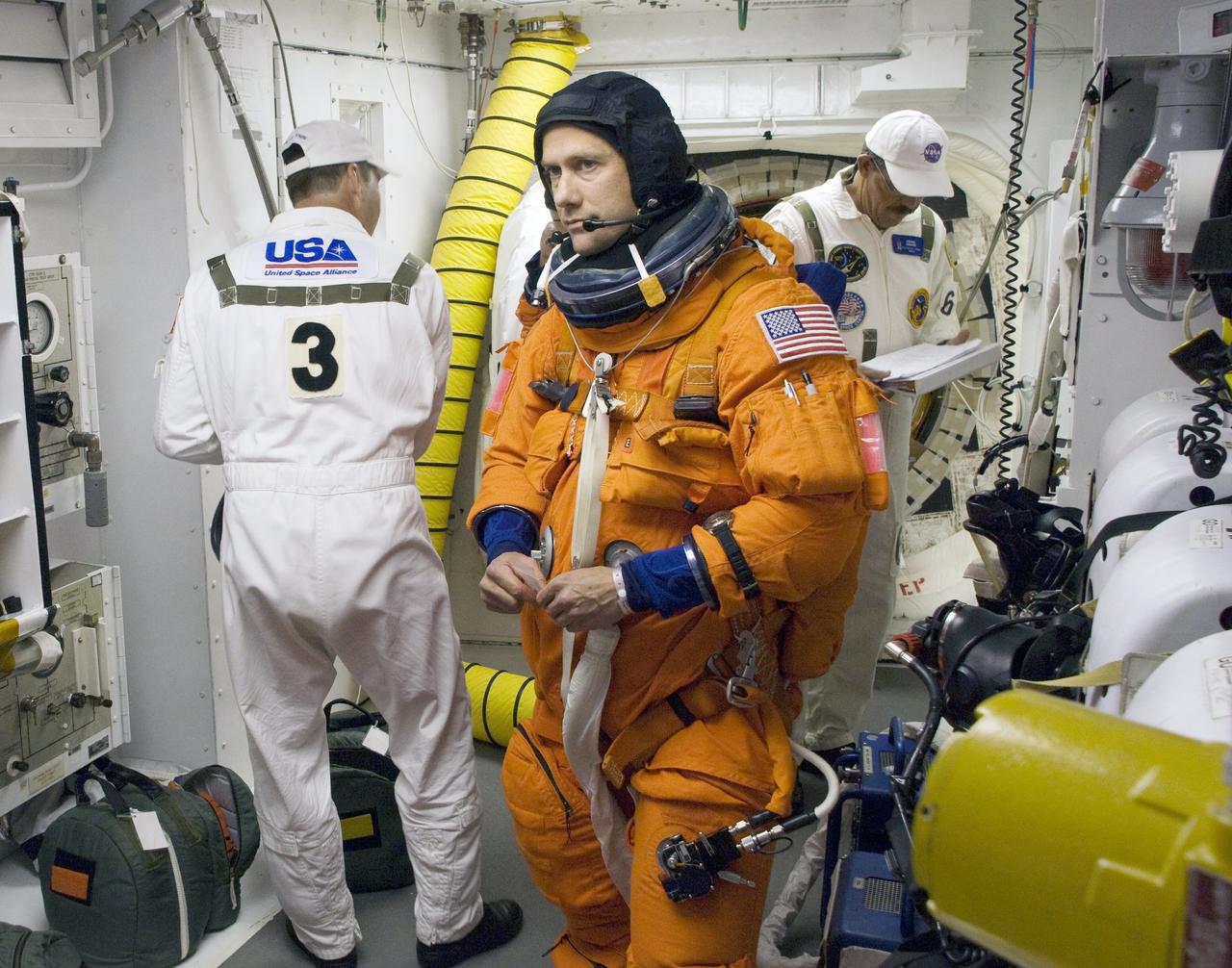 CAPE CANAVERAL, Fla. – On Launch Pad 39A at NASA's Kennedy Space Center in Florida, the closeout crew in the White Room help STS-127 crew members complete their suitup before entering space shuttle Endeavour for the 7:13 p.m. EDT liftoff.  Seen here is Mission Specialist Tom Marshburn.  This is the fourth launch attempt for the STS-127 mission. The first two launch attempts on June 13 and June 17 were scrubbed when a hydrogen gas leak occurred during tanking due to a misaligned Ground Umbilical Carrier Plate. Mission managers also decided to delay tanking on July 11 for a launch attempt later in the day to allow engineers and safety personnel time to analyze data captured during lightning strikes near the pad on July 10. Endeavour will deliver the Japanese Experiment Module's Exposed Facility, or JEM-EF, and the Experiment Logistics Module-Exposed Section, or ELM-ES, in the final of three flights dedicated to the assembly of the Japan Aerospace Exploration Agency's Kibo laboratory complex on the International Space Station.  STS-127 is the 29th flight for the assembly of the space.   Photo credit: NASA/Sandra Joseph & Kevin O'Connell