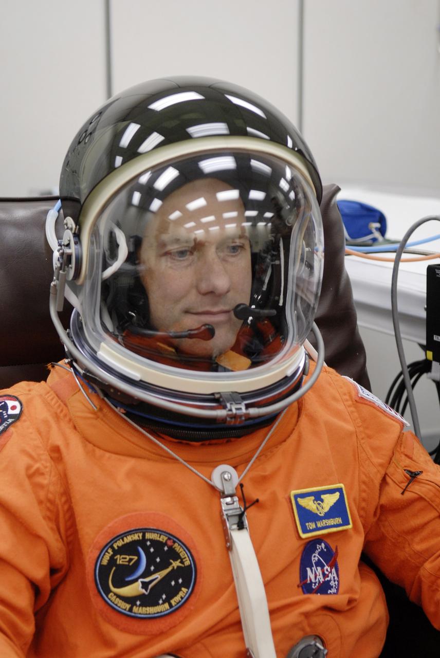 CAPE CANAVERAL, Fla. – In the Operations and Checkout Building at NASA's Kennedy Space Center in Florida, STS-127 Mission Specialist Tom Marshburn checks the communication inside his helmet before heading to Launch Pad 39A for launch on space shuttle Endeavour. Liftoff is scheduled for 6:51 p.m. EDT. Today's launch will be the fifth attempt. The mission was scrubbed on June 13 and again June 17 when a hydrogen gas leak occurred during tanking due to a misaligned Ground Umbilical Carrier Plate. The mission was scrubbed July 12 due to weather conditions near the Shuttle Landing Facility at Kennedy that violated rules for launching. Endeavour will deliver the Japanese Experiment Module's Exposed Facility, or JEM-EF, and the Experiment Logistics Module-Exposed Section, or ELM-ES, in the final of three flights dedicated to the assembly of the Japan Aerospace Exploration Agency's Kibo laboratory complex on the International Space Station. STS-127 is the 29th flight for the assembly of the space station. Photo credit: NASA/ Kim Shiflett