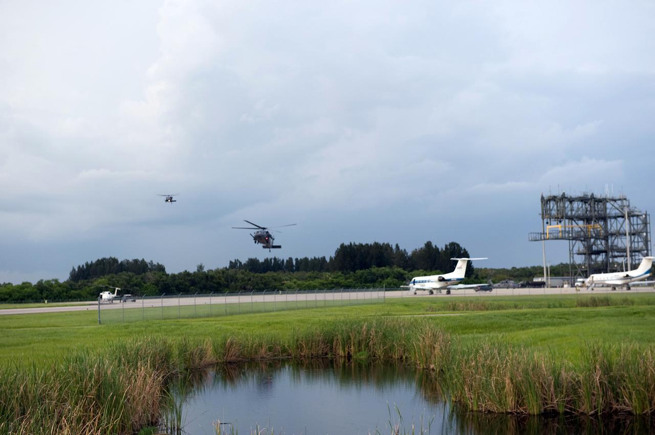 CAPE CANAVERAL, Fla. – Helicopters fly in the vicinity of the Shuttle Landing Facility at NASA's Kennedy Space Center in Florida in the event of a return-to-landing-site is needed after launch of space shuttle Endeavour on the STS-127 mission.  This is the fifth launch attempt for the STS-127 mission. The first two launch attempts on June 13 and June 17 were scrubbed when a hydrogen gas leak occurred during tanking due to a misaligned Ground Umbilical Carrier Plate. Mission managers also decided to delay tanking on July 11 for a launch attempt later in the day to allow engineers and safety personnel time to analyze data captured during lightning strikes near the pad on July 10. The fourth attempt on July 12 was scrubbed due to weather concerns as well. Photo credit: NASA/Carl Winebarger