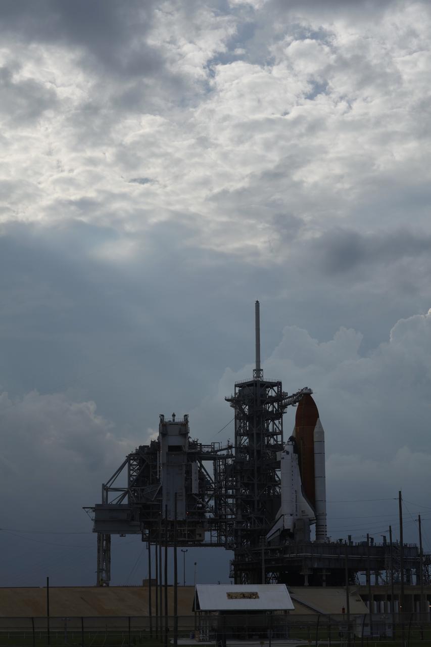 CAPE CANAVERAL, Fla. – The darkened sky over Launch Pad 39A at NASA's Kennedy Space Center in Florida reveal the decision to postpone today’s space shuttle launch because of lightning and thunderstorms within the 20-nautical-mile circle around the launch pad. The fifth launch attempt for the STS-127 mission was scrubbed at 6:39 p.m. EDT. This was the fifth launch attempt for the STS-127 mission. The first two launch attempts on June 13 and June 17 were scrubbed when a hydrogen gas leak occurred during tanking due to a misaligned Ground Umbilical Carrier Plate. Mission managers also decided to delay tanking on July 11 for a launch attempt later in the day to allow engineers and safety personnel time to analyze data captured during lightning strikes near the pad on July 10. The fourth attempt on July 12 was scrubbed due to weather concerns as well. Photo courtesy of Scott Andrews