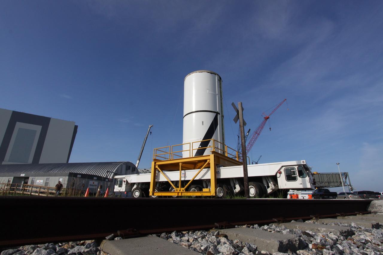 CAPE CANAVERAL, Fla. – At NASA's Kennedy Space Center in Florida, the Ares I-X forward center segment nears the Vehicle Assembly Building, or VAB, after leaving the Rotation, Processing and Surge Facility. The launch vehicle is being assembled in the VAB's High Bay 3. Part of the Constellation Program, the Ares I-X is the test vehicle for the Ares I, which is the essential core of a space transportation system that eventually will carry crewed missions back to the moon, on to Mars and out into the solar system . The Ares I-X flight test is targeted for no earlier than Aug. 30. Photo credit: NASA/Jack Pfaller