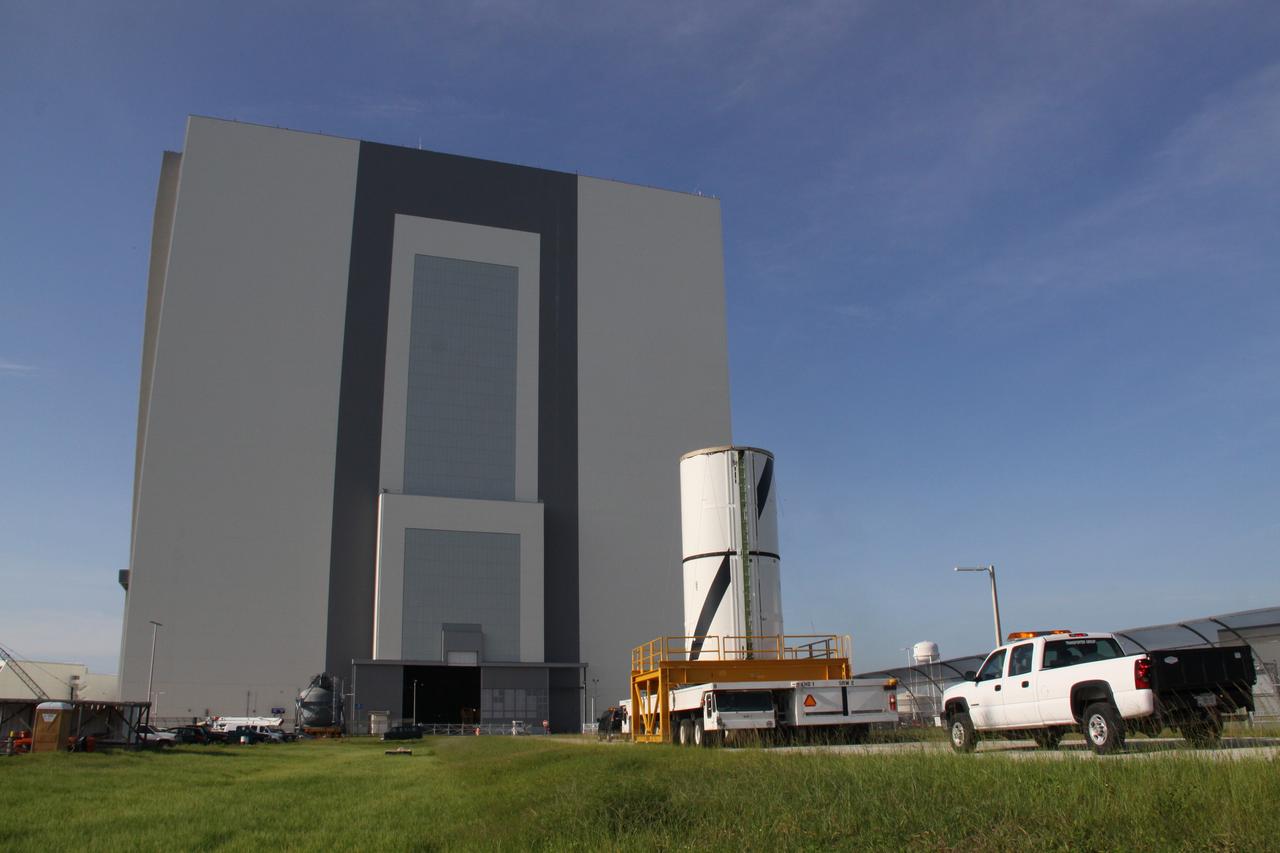 CAPE CANAVERAL, Fla. – At NASA's Kennedy Space Center in Florida, the Ares I-X forward center segment approaches the Vehicle Assembly Building, or VAB, after leaving the Rotation, Processing and Surge Facility. The launch vehicle is being assembled in the VAB's High Bay 3. Part of the Constellation Program, the Ares I-X is the test vehicle for the Ares I, which is the essential core of a space transportation system that eventually will carry crewed missions back to the moon, on to Mars and out into the solar system . The Ares I-X flight test is targeted for no earlier than Aug. 30. Photo credit: NASA/Jack Pfaller