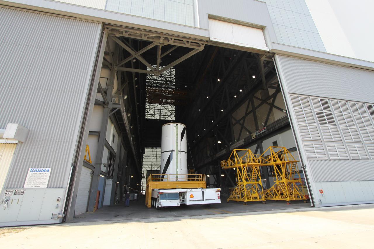 CAPE CANAVERAL, Fla. – At NASA's Kennedy Space Center in Florida, the Ares I-X forward center segment moves into the transfer aisle of the Vehicle Assembly Building, or VAB. The launch vehicle is being assembled in the VAB's High Bay 3. Part of the Constellation Program, the Ares I-X is the test vehicle for the Ares I, which is the essential core of a space transportation system that eventually will carry crewed missions back to the moon, on to Mars and out into the solar system . The Ares I-X flight test is targeted for no earlier than Aug. 30. Photo credit: NASA/Jack Pfaller