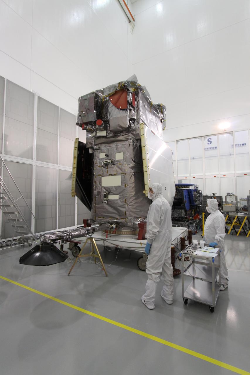 CAPE CANAVERAL, Fla. – At Astrotech Space Operations in Titusville, Fla., the lowered high-gain antenna on the Solar Dynamics Observatory will allow engineers access to the battery compartment in order to install the flight battery. SDO is the first space weather research network mission in NASA's Living With a Star Program. The spacecraft's long-term measurements will give solar scientists in-depth information about changes in the sun's magnetic field and insight into how they affect Earth. In preparation for its anticipated November launch, engineers will perform a battery of comprehensive tests to ensure SDO can withstand the stresses and vibrations of the launch itself, as well as what it will encounter in the space environment after launch. Photo credit: NASA/Jack Pfaller