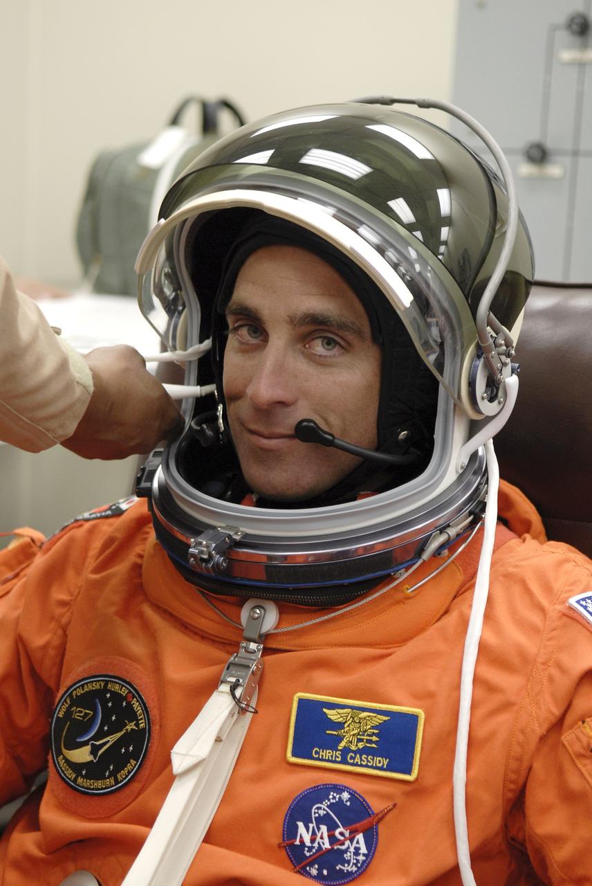 CAPE CANAVERAL, Fla. – In the Operations and Checkout Building at NASA's Kennedy Space Center in Florida, STS-127 Mission Specialist Christopher Cassidy has his helmet communications checked before heading to Launch Pad 39A for launch. Liftoff of space shuttle Endeavour is scheduled for 6:03 p.m. EDT. Today will be the sixth launch attempt for the STS-127 mission. The launch was scrubbed on June 13 and June 17 when a hydrogen gas leak occurred during tanking due to a misaligned Ground Umbilical Carrier Plate. The mission was postponed July 11, 12 and 13 due to weather conditions near the Shuttle Landing Facility at Kennedy that violated rules for launching, and lightning issues. Endeavour will deliver the Japanese Experiment Module's Exposed Facility and the Experiment Logistics Module-Exposed Section in the final of three flights dedicated to the assembly of the Japan Aerospace Exploration Agency's Kibo laboratory complex on the International Space Station. Photo credit: NASA/ Kim Shiflett