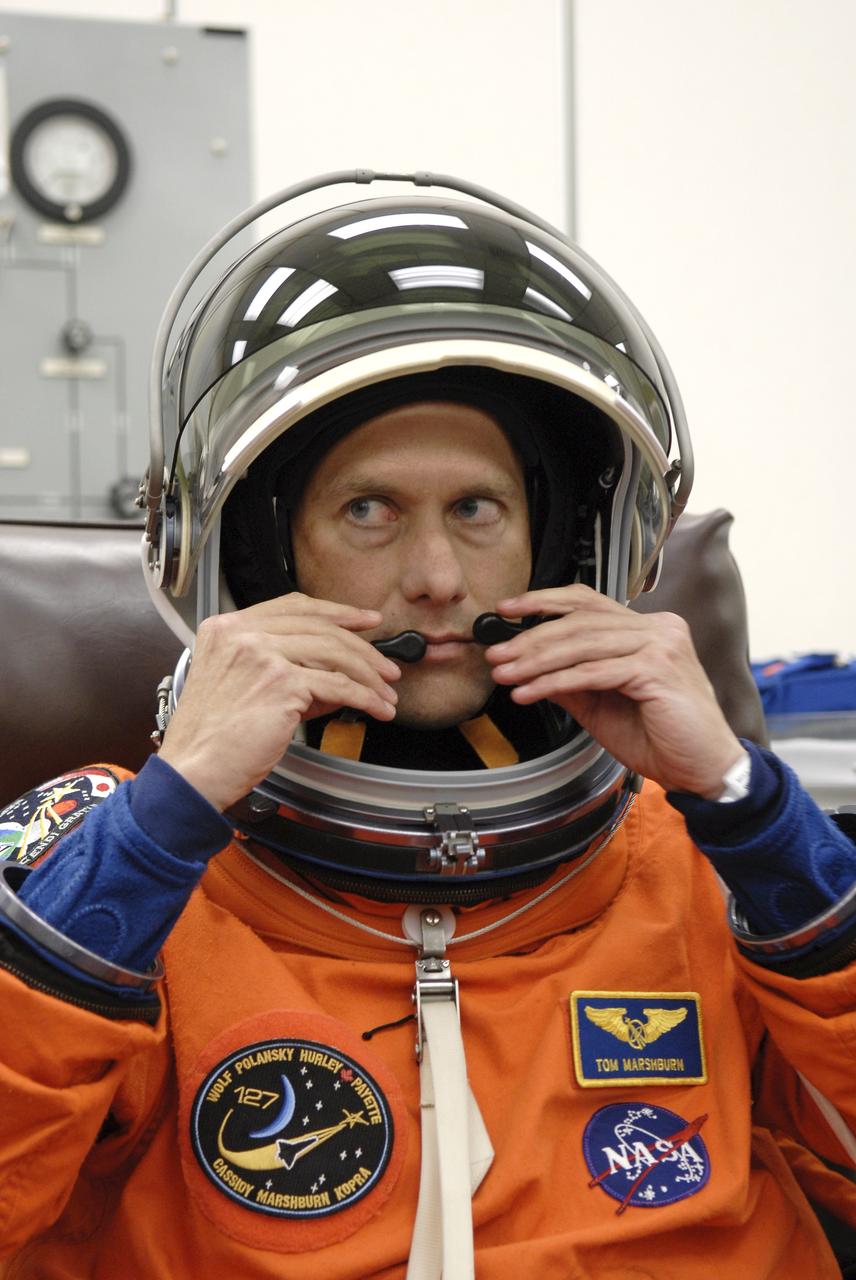 CAPE CANAVERAL, Fla. – In the Operations and Checkout Building at NASA's Kennedy Space Center in Florida, STS-127 Mission Specialist Tom Marshburn checks the communication apparatus in his helmet before heading to Launch Pad 39A for launch. Liftoff of space shuttle Endeavour is scheduled for 6:03 p.m. EDT. Today will be the sixth launch attempt for the STS-127 mission. The launch was scrubbed on June 13 and June 17 when a hydrogen gas leak occurred during tanking due to a misaligned Ground Umbilical Carrier Plate. The mission was postponed July 11, 12 and 13 due to weather conditions near the Shuttle Landing Facility at Kennedy that violated rules for launching, and lightning issues. Endeavour will deliver the Japanese Experiment Module's Exposed Facility and the Experiment Logistics Module-Exposed Section in the final of three flights dedicated to the assembly of the Japan Aerospace Exploration Agency's Kibo laboratory complex on the International Space Station. Photo credit: NASA/ Kim Shiflett