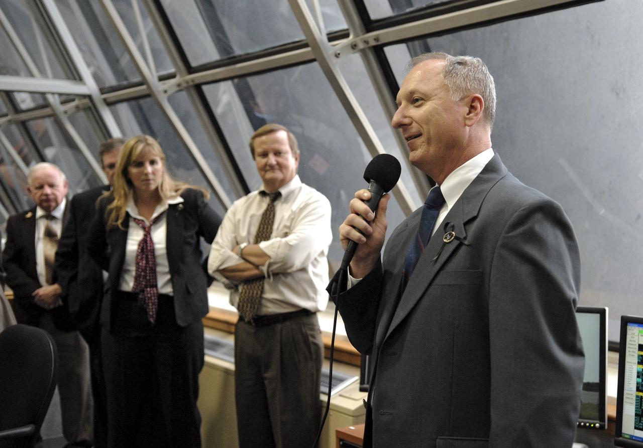 CAPE CANAVERAL, Fla. – In the Firing Room at NASA's Kennedy Space Center in Florida,  STS-127 Shuttle Launch Director Pete Nickolenko  (right) congratulates the mission team for the  successful launch of space shuttle Endeavour on the STS-127 mission.  Liftoff was on-time at 6:03 p.m. EDT.  At left are Endeavour Flow Director Dana Hutcherson  and Shuttle Launch Director Mike Leinbach.  Today was the sixth launch attempt for the STS-127 mission.  The launch was scrubbed on June 13 and June 17 when a hydrogen gas leak occurred during tanking due to a misaligned Ground Umbilical Carrier Plate.  The mission was postponed July 11, 12 and 13 due to weather conditions near the Shuttle Landing Facility at Kennedy that violated rules for launching, and lightning issues. Endeavour will deliver the Japanese Experiment Module's Exposed Facility and the Experiment Logistics Module-Exposed Section in the final of three flights dedicated to the assembly of the Japan Aerospace Exploration Agency's Kibo laboratory complex on the International Space Station.   Photo credit: NASA/Kim Shiflett