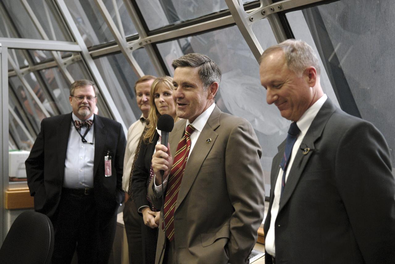 CAPE CANAVERAL, Fla. – In the Firing Room at NASA's Kennedy Space Center in Florida, Center Director Bob Cabana congratulates the mission team for the successful launch of space shuttle Endeavour on the STS-127 mission. Liftoff was on-time at 6:03 p.m. EDT. Looking on at left are Associate Administrator of Program Analysis & Evaluation at NASA Dr. Michael Hawes, Shuttle Launch Director Mike Leinbach and Endeavour Flow Director Dana Hutcherson , and at right, STS-127 Shuttle Launch Director Pete Nickolenko. Today was the sixth launch attempt for the STS-127 mission. The launch was scrubbed on June 13 and June 17 when a hydrogen gas leak occurred during tanking due to a misaligned Ground Umbilical Carrier Plate. The mission was postponed July 11, 12 and 13 due to weather conditions near the Shuttle Landing Facility at Kennedy that violated rules for launching, and lightning issues. Endeavour will deliver the Japanese Experiment Module's Exposed Facility and the Experiment Logistics Module-Exposed Section in the final of three flights dedicated to the assembly of the Japan Aerospace Exploration Agency's Kibo laboratory complex on the International Space Station. Photo credit: NASA/Kim Shiflett