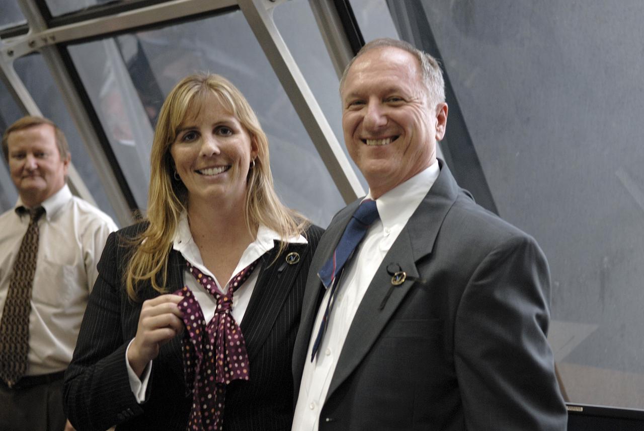 CAPE CANAVERAL, Fla. – In the Firing Room at NASA's Kennedy Space Center in Florida,  Endeavour Flow Director Dana Hutcherson and STS-127 Shuttle Launch Director Pete Nickolenko shared in the tie-cutting ceremony for their inaugural launch. At left is Shuttle Launch Director Mike Leinbach.  Space shuttle Endeavour lifted off on-time at 6:03 p.m. EDT on the STS-127 mission. Today was the sixth launch attempt for the STS-127 mission.  The launch was scrubbed on June 13 and June 17 when a hydrogen gas leak occurred during tanking due to a misaligned Ground Umbilical Carrier Plate.  The mission was postponed July 11, 12 and 13 due to weather conditions near the Shuttle Landing Facility at Kennedy that violated rules for launching, and lightning issues. Endeavour will deliver the Japanese Experiment Module's Exposed Facility and the Experiment Logistics Module-Exposed Section in the final of three flights dedicated to the assembly of the Japan Aerospace Exploration Agency's Kibo laboratory complex on the International Space Station.   Photo credit: NASA/Kim Shiflett