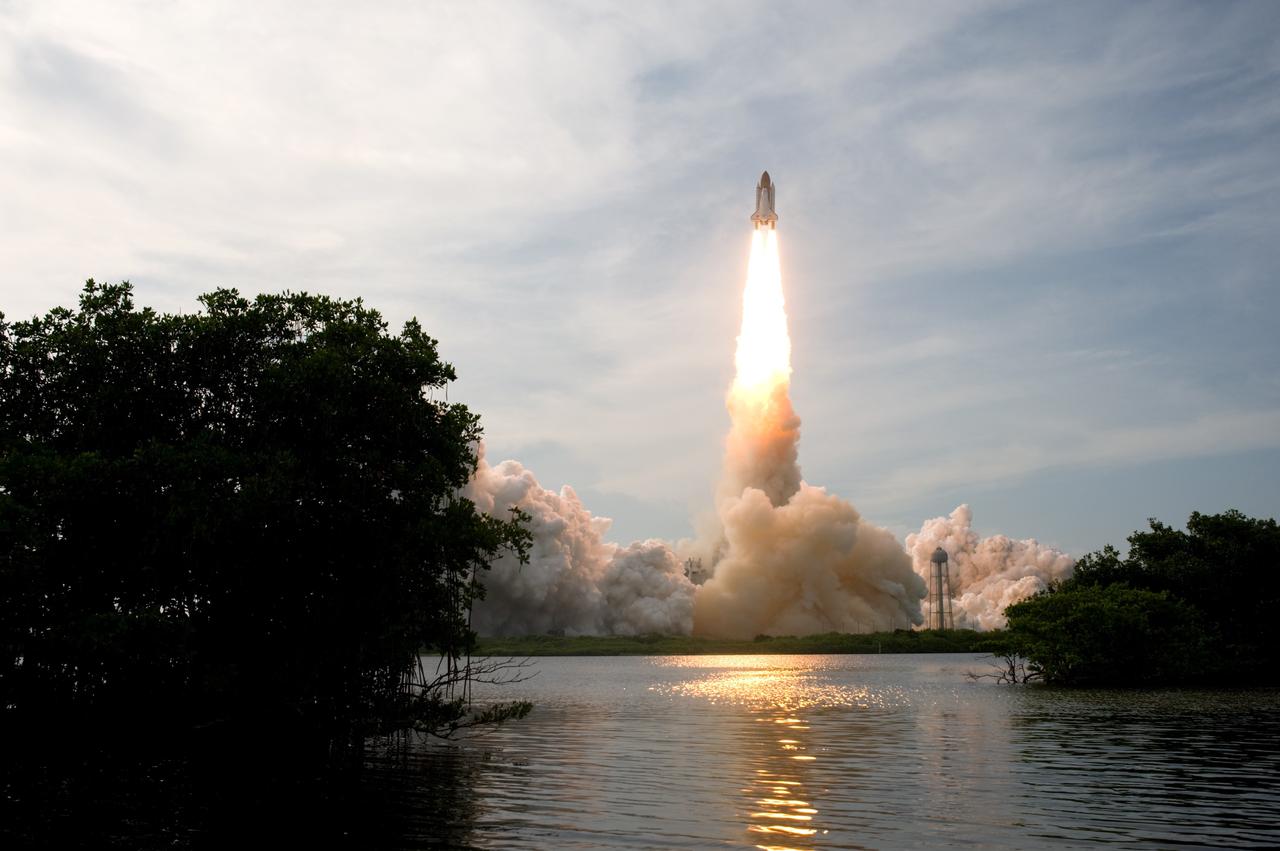 CAPE CANAVERAL, Fla. – Trailing fire, space shuttle Endeavour roars into the cloud-washed sky from Launch Pad 39A at NASA's Kennedy Space Center in Florida on the STS-127 mission.  Liftoff was on-time at 6:03 p.m. EDT. Today was the sixth launch attempt for the STS-127 mission.  The launch was scrubbed on June 13 and June 17 when a hydrogen gas leak occurred during tanking due to a misaligned Ground Umbilical Carrier Plate.  The mission was postponed July 11, 12 and 13 due to weather conditions near the Shuttle Landing Facility at Kennedy that violated rules for launching, and lightning issues. Endeavour will deliver the Japanese Experiment Module's Exposed Facility and the Experiment Logistics Module-Exposed Section in the final of three flights dedicated to the assembly of the Japan Aerospace Exploration Agency's Kibo laboratory complex on the International Space Station.   Photo credit: NASA/Sandra Joseph, Kevin O'Connell