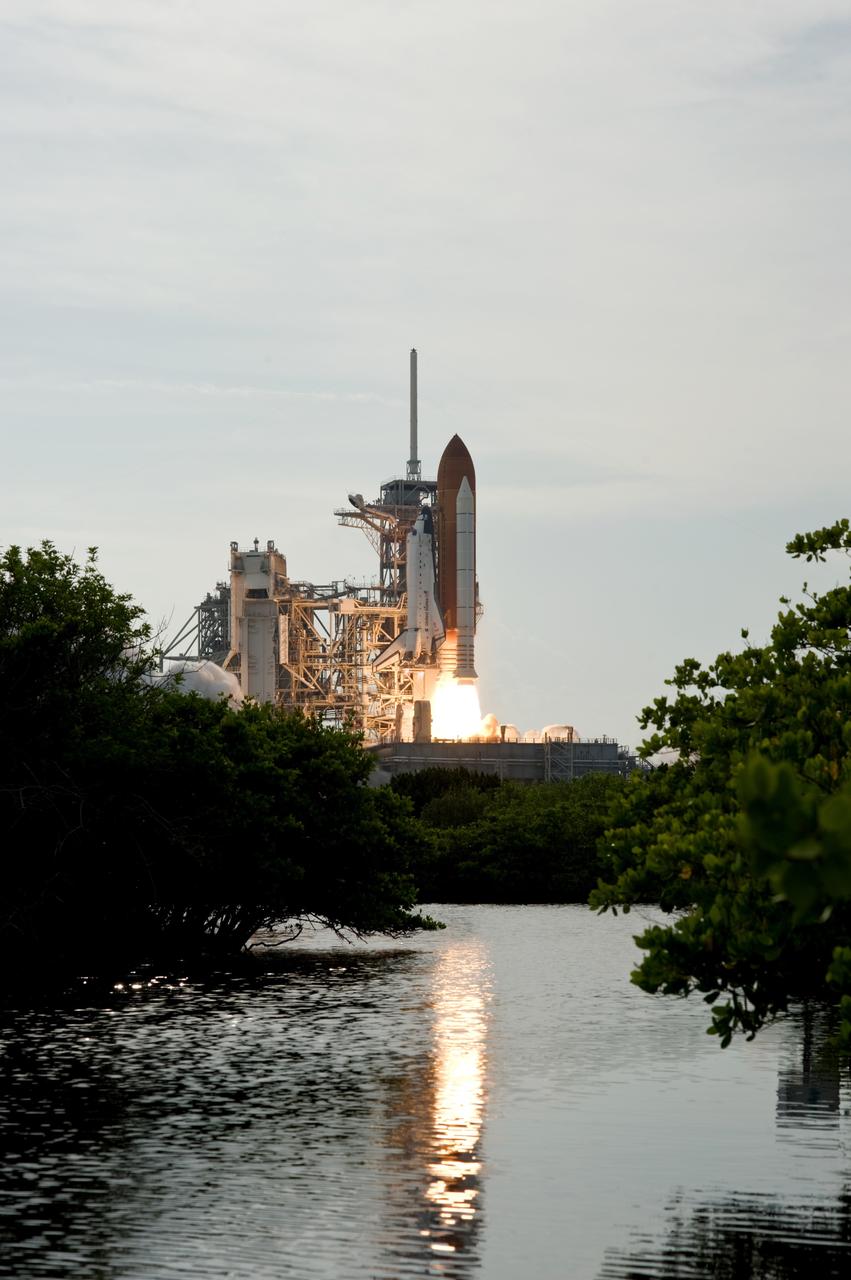 CAPE CANAVERAL, Fla. – The fire of space shuttle Endeavour's launch is reflected in the Banana River near NASA Kennedy Space Center's Launch Pad 39A.  Liftoff of Endeavour on the STS-127 mission was on-time at 6:03 p.m. EDT.  Liftoff was on-time at 6:03 p.m. EDT. Today was the sixth launch attempt for the STS-127 mission.  The launch was scrubbed on June 13 and June 17 when a hydrogen gas leak occurred during tanking due to a misaligned Ground Umbilical Carrier Plate.  The mission was postponed July 11, 12 and 13 due to weather conditions near the Shuttle Landing Facility at Kennedy that violated rules for launching, and lightning issues. Endeavour will deliver the Japanese Experiment Module's Exposed Facility and the Experiment Logistics Module-Exposed Section in the final of three flights dedicated to the assembly of the Japan Aerospace Exploration Agency's Kibo laboratory complex on the International Space Station.   Photo credit: NASA/Sandra Joseph, Kevin O'Connell