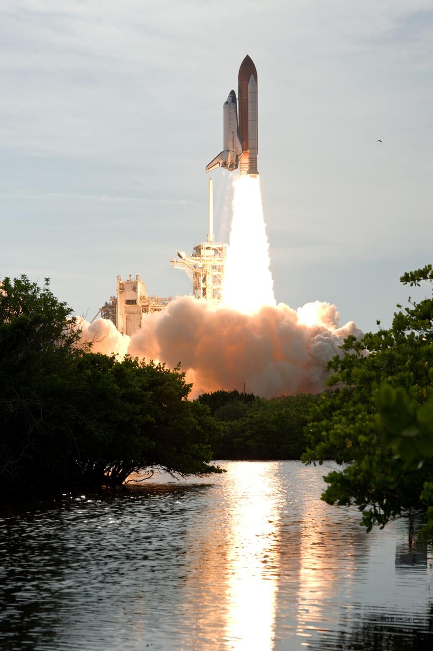 CAPE CANAVERAL, Fla. – The Banana River seems to burn as space shuttle Endeavour's column of flame is reflected at liftoff on the STS-127 mission.  Liftoff was on-time at 6:03 p.m. EDT.  Today was the sixth launch attempt for the STS-127 mission.  The launch was scrubbed on June 13 and June 17 when a hydrogen gas leak occurred during tanking due to a misaligned Ground Umbilical Carrier Plate.  The mission was postponed July 11, 12 and 13 due to weather conditions near the Shuttle Landing Facility at Kennedy that violated rules for launching, and lightning issues. Endeavour will deliver the Japanese Experiment Module's Exposed Facility and the Experiment Logistics Module-Exposed Section in the final of three flights dedicated to the assembly of the Japan Aerospace Exploration Agency's Kibo laboratory complex on the International Space Station.   Photo credit: NASA/Sandra Joseph, Kevin O'Connell