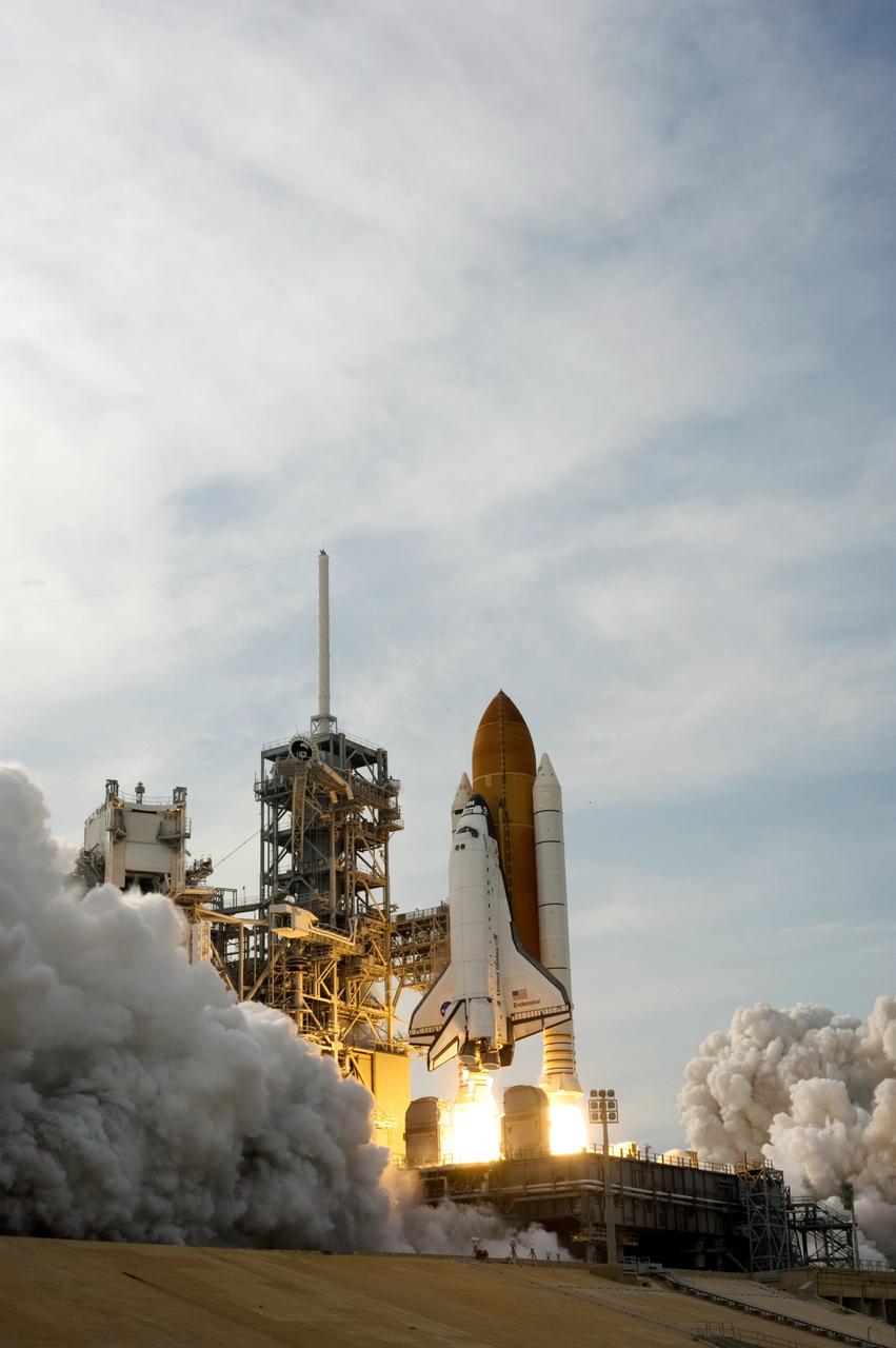 CAPE CANAVERAL, Fla. – Twin columns of fire lift space shuttle Endeavour toward the sky from NASA Kennedy Space Center's Launch Pad 39A on the STS-127 mission.   Liftoff was on-time at 6:03 p.m. EDT.  Today was the sixth launch attempt for the STS-127 mission.  The launch was scrubbed on June 13 and June 17 when a hydrogen gas leak occurred during tanking due to a misaligned Ground Umbilical Carrier Plate.  The mission was postponed July 11, 12 and 13 due to weather conditions near the Shuttle Landing Facility at Kennedy that violated rules for launching, and lightning issues. Endeavour will deliver the Japanese Experiment Module's Exposed Facility and the Experiment Logistics Module-Exposed Section in the final of three flights dedicated to the assembly of the Japan Aerospace Exploration Agency's Kibo laboratory complex on the International Space Station.   Photo credit: NASA/Sandra Joseph, Kevin O'Connell