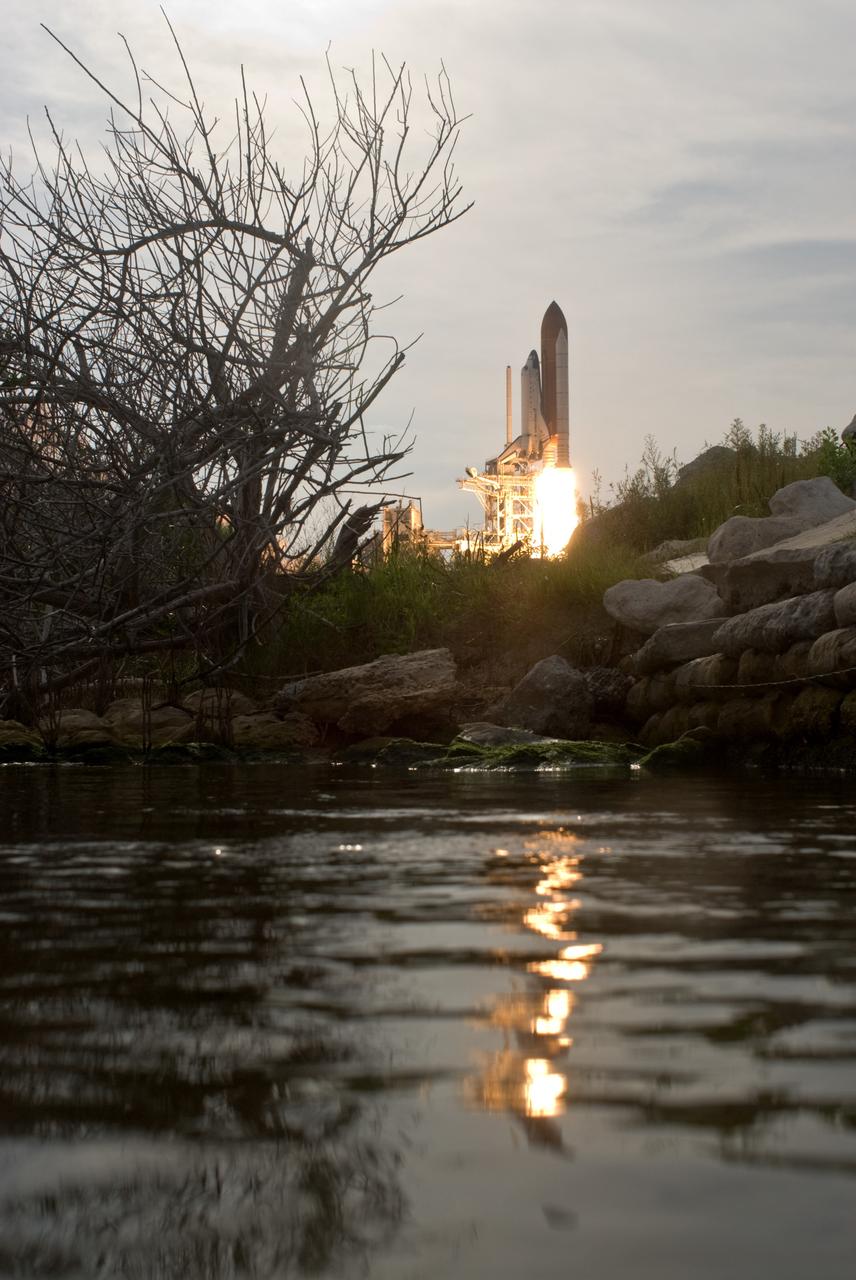 CAPE CANAVERAL, Fla. – From across the water, space shuttle Endeavour rises powerfully from NASA Kennedy Space Center's Launch Pad 39A on the STS-127 mission. Liftoff was on-time at 6:03 p.m. EDT. Today was the sixth launch attempt for the STS-127 mission.  The launch was scrubbed on June 13 and June 17 when a hydrogen gas leak occurred during tanking due to a misaligned Ground Umbilical Carrier Plate.  The mission was postponed July 11, 12 and 13 due to weather conditions near the Shuttle Landing Facility at Kennedy that violated rules for launching, and lightning issues. Endeavour will deliver the Japanese Experiment Module's Exposed Facility and the Experiment Logistics Module-Exposed Section in the final of three flights dedicated to the assembly of the Japan Aerospace Exploration Agency's Kibo laboratory complex on the International Space Station.   Photo credit: NASA/Tony Gray, Tom Farrar