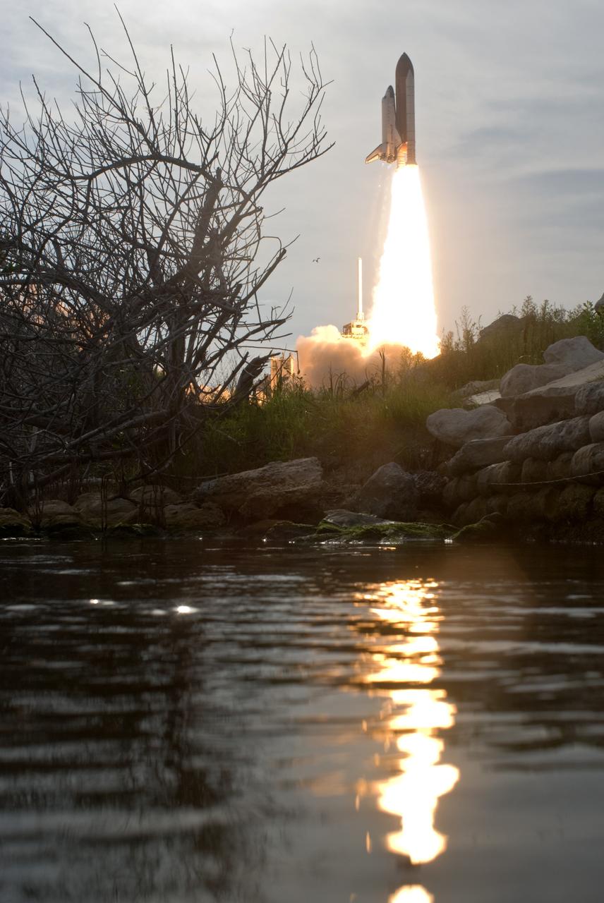 CAPE CANAVERAL, Fla. – The nearby water captures the brilliant light from space shuttle Endeavour's liftoff from NASA Kennedy Space Center's Launch Pad 39A on the STS-127 mission. Liftoff was on-time at 6:03 p.m. EDT. Today was the sixth launch attempt for the STS-127 mission.  The launch was scrubbed on June 13 and June 17 when a hydrogen gas leak occurred during tanking due to a misaligned Ground Umbilical Carrier Plate.  The mission was postponed July 11, 12 and 13 due to weather conditions near the Shuttle Landing Facility at Kennedy that violated rules for launching, and lightning issues. Endeavour will deliver the Japanese Experiment Module's Exposed Facility and the Experiment Logistics Module-Exposed Section in the final of three flights dedicated to the assembly of the Japan Aerospace Exploration Agency's Kibo laboratory complex on the International Space Station.   Photo credit: NASA/Tony Gray, Tom Farrar