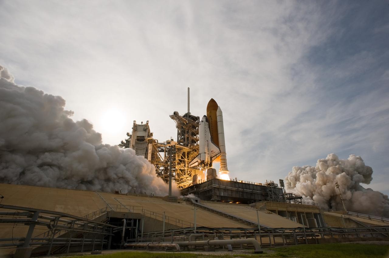 CAPE CANAVERAL, Fla. – Framed by smoke and steam, space shuttle Endeavour leaps from NASA Kennedy Space Center's Launch Pad 39A on the STS-127 mission.  Liftoff was on-time at 6:03 p.m. EDT. Today was the sixth launch attempt for the STS-127 mission.  The launch was scrubbed on June 13 and June 17 when a hydrogen gas leak occurred during tanking due to a misaligned Ground Umbilical Carrier Plate.  The mission was postponed July 11, 12 and 13 due to weather conditions near the Shuttle Landing Facility at Kennedy that violated rules for launching, and lightning issues. Endeavour will deliver the Japanese Experiment Module's Exposed Facility and the Experiment Logistics Module-Exposed Section in the final of three flights dedicated to the assembly of the Japan Aerospace Exploration Agency's Kibo laboratory complex on the International Space Station.   Photo credit: NASA/Sandra Joseph, Kevin O'Connell