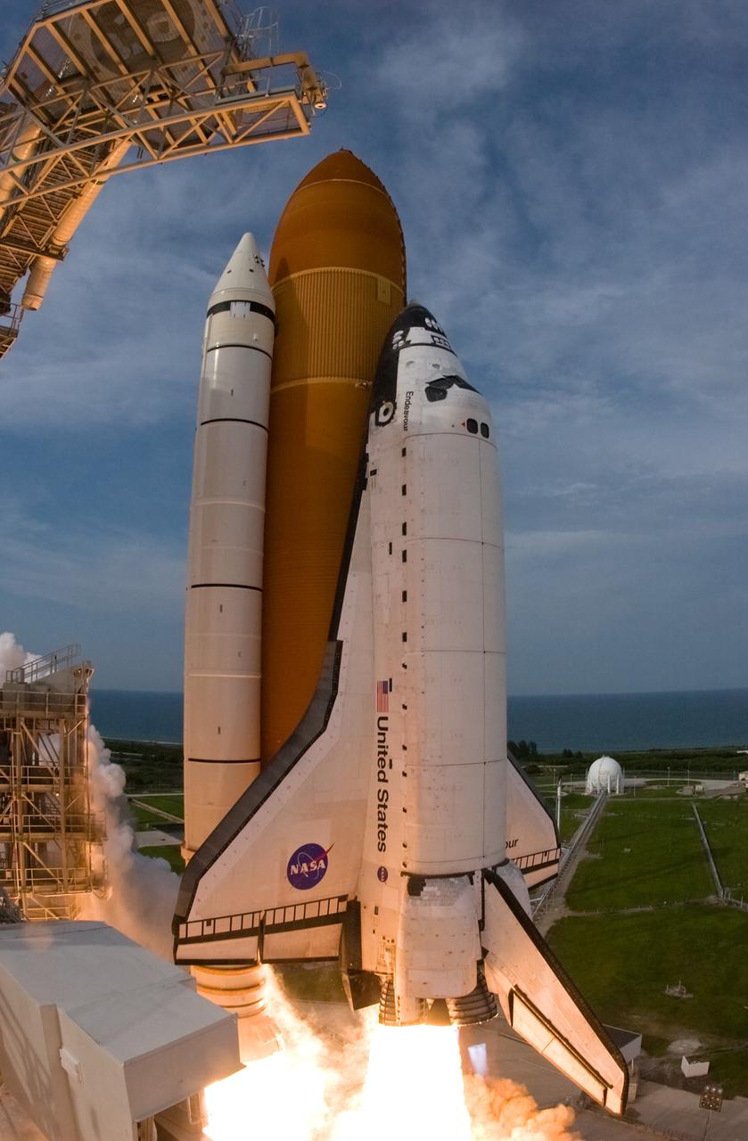 CAPE CANAVERAL, Fla. – A fish-eye view captures this close view of space shuttle Endeavour as it leaps from NASA Kennedy Space Center's Launch Pad 39A on the STS-127 mission. Liftoff was on-time at 6:03 p.m. EDT. Today was the sixth launch attempt for the STS-127 mission.  The launch was scrubbed on June 13 and June 17 when a hydrogen gas leak occurred during tanking due to a misaligned Ground Umbilical Carrier Plate.  The mission was postponed July 11, 12 and 13 due to weather conditions near the Shuttle Landing Facility at Kennedy that violated rules for launching, and lightning issues. Endeavour will deliver the Japanese Experiment Module's Exposed Facility and the Experiment Logistics Module-Exposed Section in the final of three flights dedicated to the assembly of the Japan Aerospace Exploration Agency's Kibo laboratory complex on the International Space Station.   Photo credit: NASA/Sandra Joseph, Kevin O'Connell