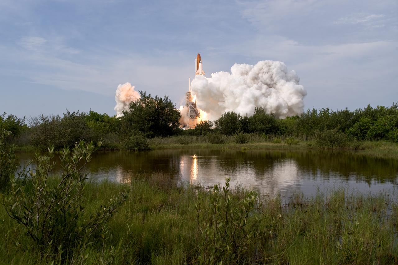 CAPE CANAVERAL, Fla. – Space shuttle Endeavour emerges from the cloud of smoke and steam on NASA Kennedy Space Center's Launch Pad 39A as it roars into space on the STS-127 mission. Liftoff was on-time at 6:03 p.m. EDT. Today was the sixth launch attempt for the STS-127 mission.  The launch was scrubbed on June 13 and June 17 when a hydrogen gas leak occurred during tanking due to a misaligned Ground Umbilical Carrier Plate.  The mission was postponed July 11, 12 and 13 due to weather conditions near the Shuttle Landing Facility at Kennedy that violated rules for launching, and lightning issues. Endeavour will deliver the Japanese Experiment Module's Exposed Facility and the Experiment Logistics Module-Exposed Section in the final of three flights dedicated to the assembly of the Japan Aerospace Exploration Agency's Kibo laboratory complex on the International Space Station.   Photo credit: NASA/Tony Gray, Tom Farrar