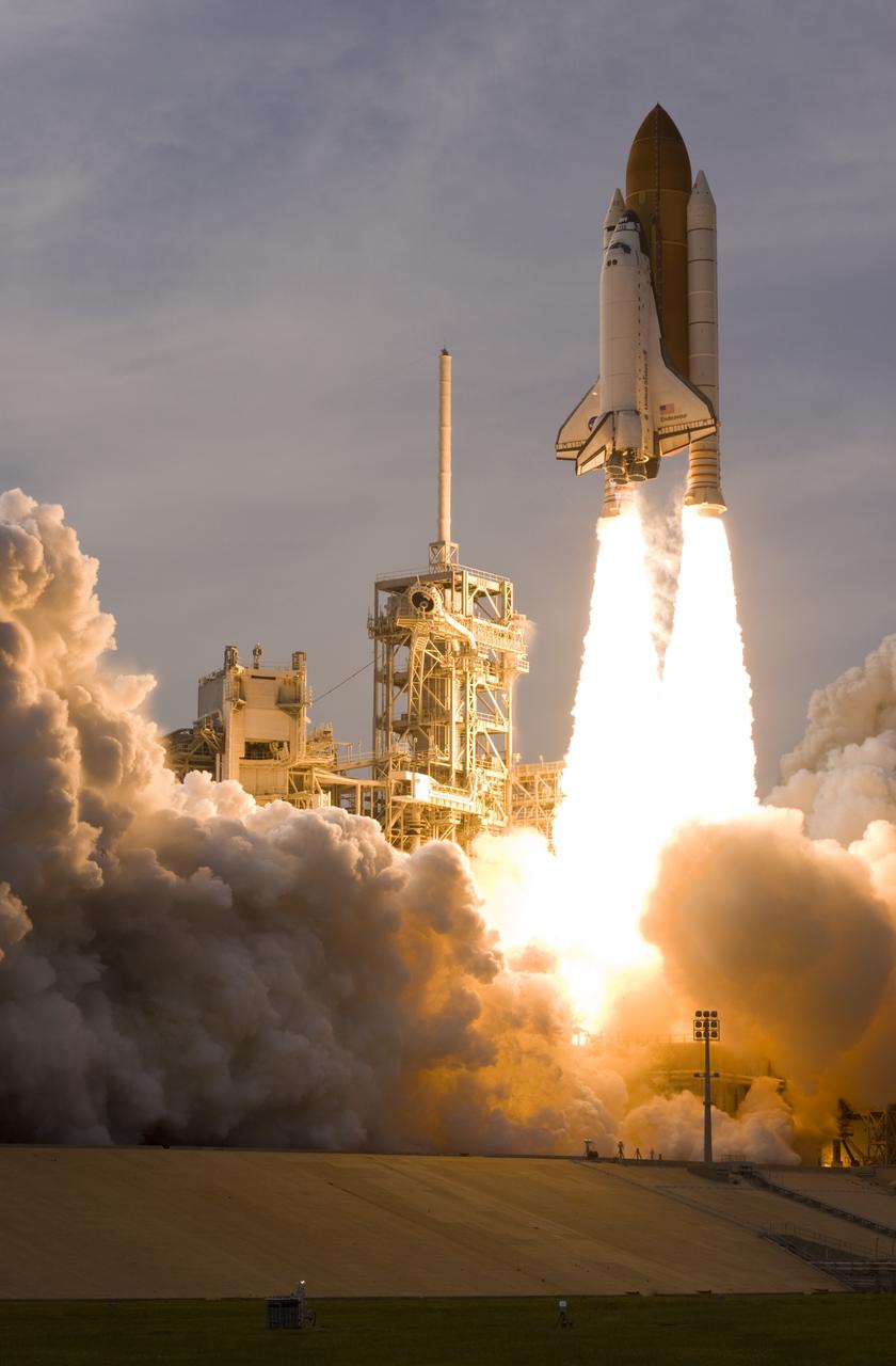 CAPE CANAVERAL, Fla. – Space shuttle Endeavour leaps from NASA Kennedy Space Center's Launch Pad 39A, passing the lightning mast on the fixed service structure, as it heads for space on the STS-127 mission. Liftoff was on-time at 6:03 p.m. EDT. This was the sixth launch attempt for the STS-127 mission.  The launch was scrubbed on June 13 and June 17 when a hydrogen gas leak occurred during tanking due to a misaligned Ground Umbilical Carrier Plate.  The mission was postponed July 11, 12 and 13 due to weather conditions near the Shuttle Landing Facility at Kennedy that violated rules for launching, and lightning issues. Endeavour will deliver the Japanese Experiment Module's Exposed Facility and the Experiment Logistics Module-Exposed Section in the final of three flights dedicated to the assembly of the Japan Aerospace Exploration Agency's Kibo laboratory complex on the International Space Station.   Photo courtesy of Scott Andrews