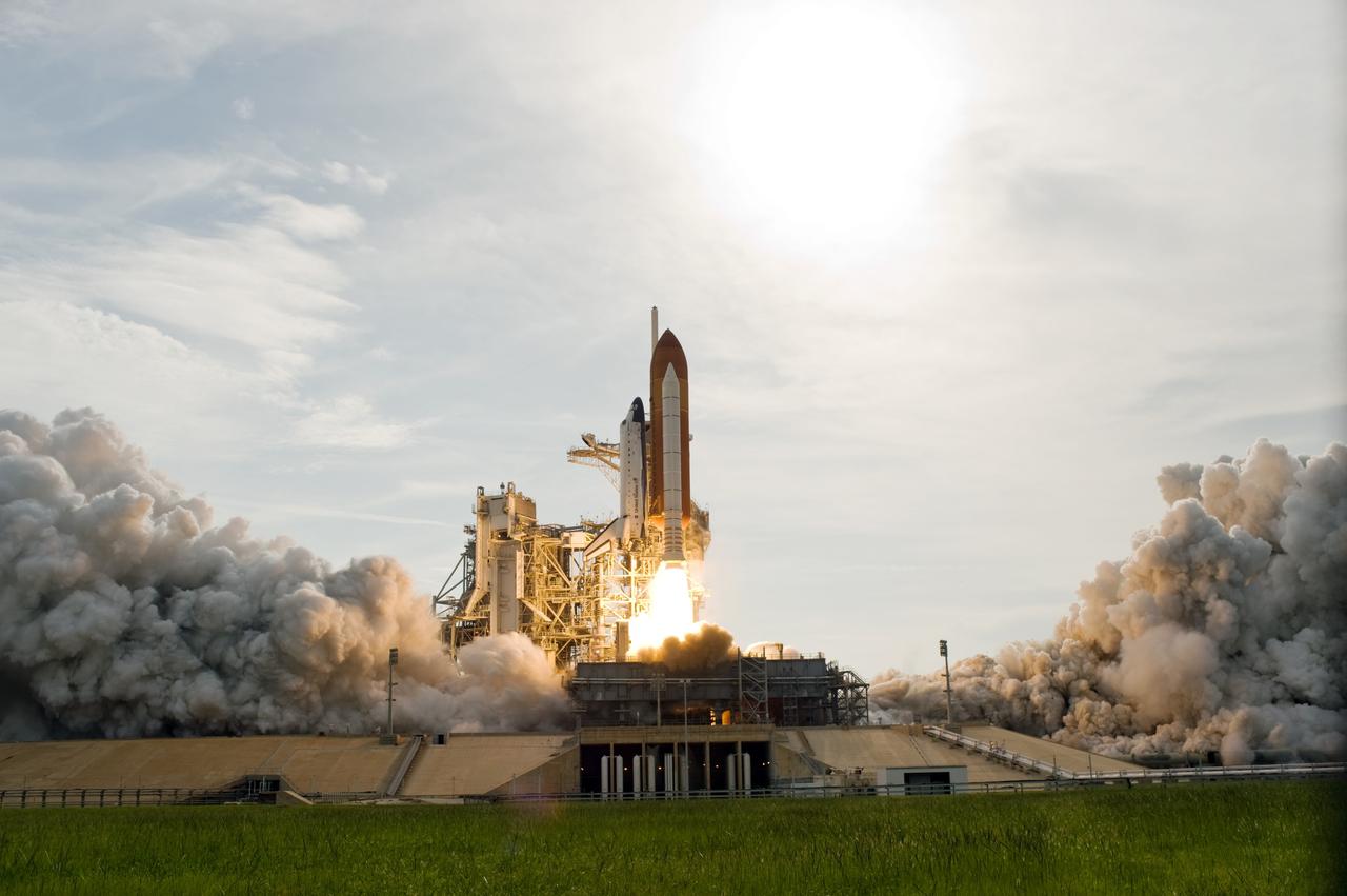 CAPE CANAVERAL, Fla. – – The brilliance of space shuttle Endeavour's launch from NASA Kennedy Space Center's Launch Pad 39A is reflected in the cloud-washed sky.  Liftoff of  Endeavour on the STS-127 mission was on-time at 6:03 p.m. EDT.  This was the sixth launch attempt for the STS-127 mission.  The launch was scrubbed on June 13 and June 17 when a hydrogen gas leak occurred during tanking due to a misaligned Ground Umbilical Carrier Plate.  The mission was postponed July 11, 12 and 13 due to weather conditions near the Shuttle Landing Facility at Kennedy that violated rules for launching, and lightning issues. Endeavour will deliver the Japanese Experiment Module's Exposed Facility and the Experiment Logistics Module-Exposed Section in the final of three flights dedicated to the assembly of the Japan Aerospace Exploration Agency's Kibo laboratory complex on the International Space Station.   Photo credit: NASA/Tony Gray, Tom Farrar