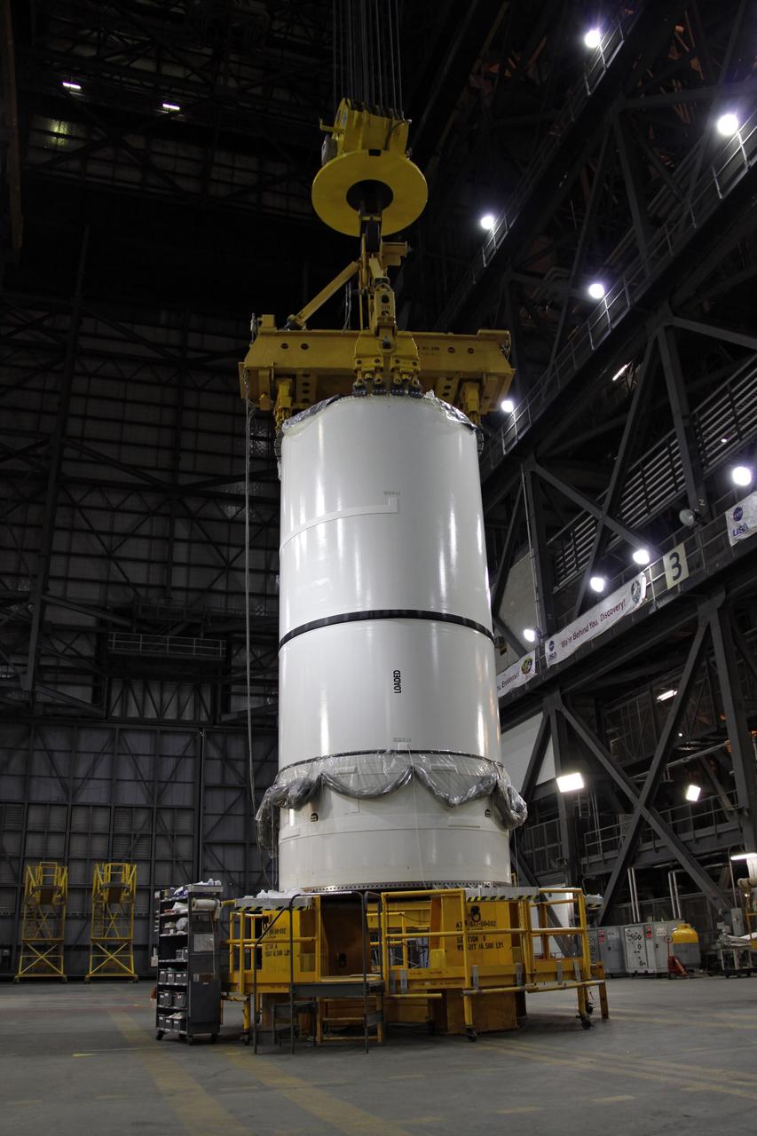 CAPE CANAVERAL, Fla. –  A crane is attached to the Ares I-X forward center assembly in NASA Kennedy Space Center's Vehicle Assembly Building. It will be mated with the aft center assembly. Part of the Constellation Program, the Ares I-X is the test vehicle for the Ares I, which is the essential core of a space transportation system that eventually will carry crewed missions back to the moon, on to Mars and out into the solar system . The Ares I-X flight test is targeted for no earlier than Aug. 30. Photo credit: NASA/Troy Cryder