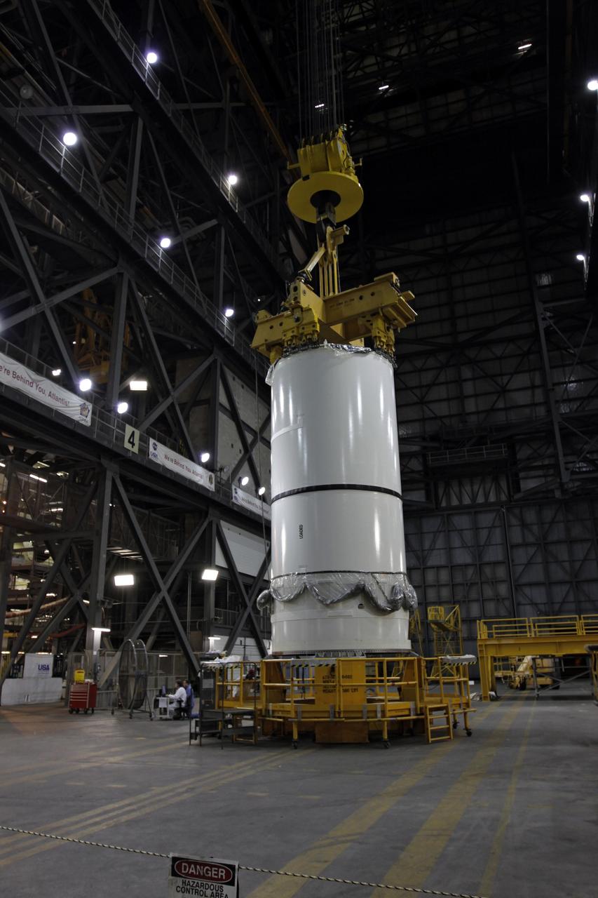 CAPE CANAVERAL, Fla. – A crane is attached to the Ares I-X forward center assembly in NASA Kennedy Space Center's Vehicle Assembly Building. The assembly will be lifted into High Bay 3 for stacking with the aft assembly. Part of the Constellation Program, the Ares I-X is the test vehicle for the Ares I, which is the essential core of a space transportation system that eventually will carry crewed missions back to the moon, on to Mars and out into the solar system . The Ares I-X flight test is targeted for no earlier than Aug. 30. Photo credit: NASA/Troy Cryder