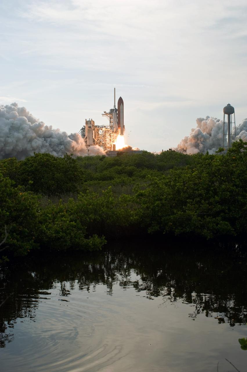 CAPE CANAVERAL, Fla. – From across a pond, space shuttle Endeavour leaps from NASA Kennedy Space Center's Launch Pad 39A, propelled by columns of fire, on the STS-127 mission. Liftoff was on-time at 6:03 p.m. EDT. This was the sixth launch attempt for the STS-127 mission.  The launch was scrubbed on June 13 and June 17 when a hydrogen gas leak occurred during tanking due to a misaligned Ground Umbilical Carrier Plate.  The mission was postponed July 11, 12 and 13 due to weather conditions near the Shuttle Landing Facility at Kennedy that violated rules for launching, and lightning issues. Endeavour will deliver the Japanese Experiment Module's Exposed Facility and the Experiment Logistics Module-Exposed Section in the final of three flights dedicated to the assembly of the Japan Aerospace Exploration Agency's Kibo laboratory complex on the International Space Station.   Photo credit: NASA/Tony Gray, Tom Farrar