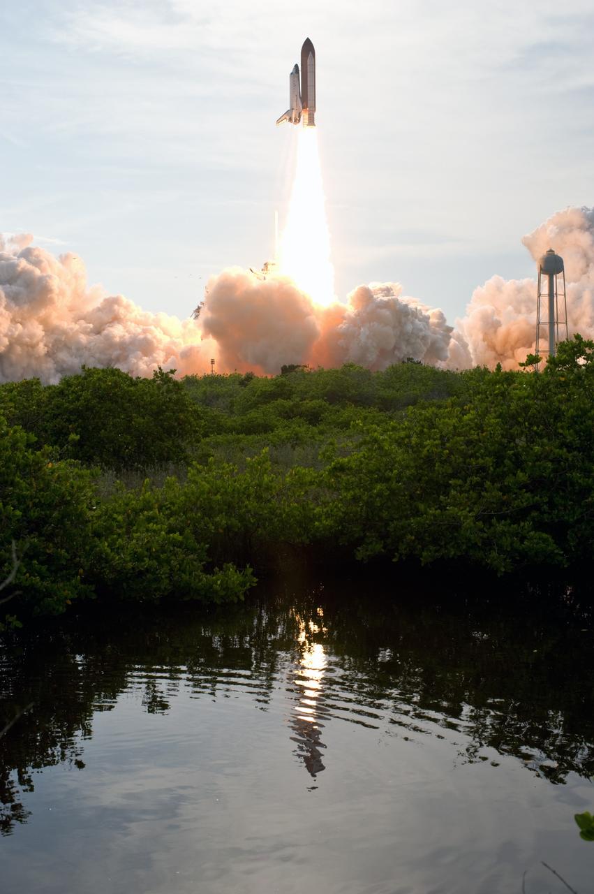 CAPE CANAVERAL, Fla. – – Space shuttle Endeavour's climb toward space from NASA Kennedy Space Center's Launch Pad 39A is captured in the nearby pond.  The launch vibrations ripple the water. Liftoff was on-time at 6:03 p.m. EDT.  This was the sixth launch attempt for the STS-127 mission.  The launch was scrubbed on June 13 and June 17 when a hydrogen gas leak occurred during tanking due to a misaligned Ground Umbilical Carrier Plate.  The mission was postponed July 11, 12 and 13 due to weather conditions near the Shuttle Landing Facility at Kennedy that violated rules for launching, and lightning issues. Endeavour will deliver the Japanese Experiment Module's Exposed Facility and the Experiment Logistics Module-Exposed Section in the final of three flights dedicated to the assembly of the Japan Aerospace Exploration Agency's Kibo laboratory complex on the International Space Station.   Photo credit: NASA/Tony Gray, Tom Farrar