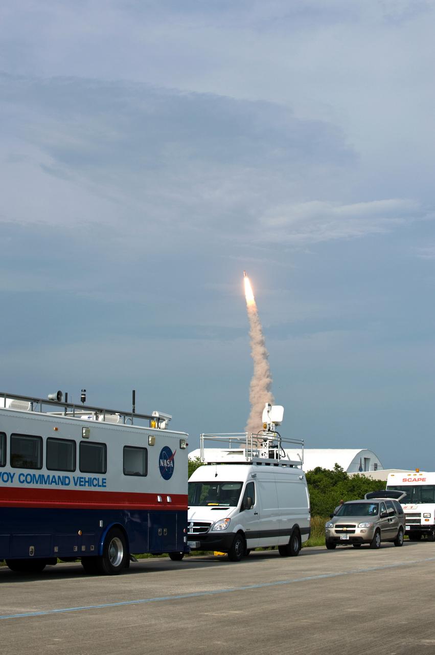 CAPE CANAVERAL, Fla. – Space shuttle Endeavour soars into the sky on the STS-127 mission from NASA Kennedy Space Center as convoy command and SCAPE vehicles are in position at the Shuttle Landing Facility in the event a return-to-landing-site is needed. Liftoff was on-time at 6:03 p.m. EDT.  This was the sixth launch attempt for the STS-127 mission.  The launch was scrubbed on June 13 and June 17 when a hydrogen gas leak occurred during tanking due to a misaligned Ground Umbilical Carrier Plate.  The mission was postponed July 11, 12 and 13 due to weather conditions near the Shuttle Landing Facility at Kennedy that violated rules for launching, and lightning issues. Endeavour will deliver the Japanese Experiment Module's Exposed Facility and the Experiment Logistics Module-Exposed Section in the final of three flights dedicated to the assembly of the Japan Aerospace Exploration Agency's Kibo laboratory complex on the International Space Station.   Photo credit: NASA/Carl Winebarger