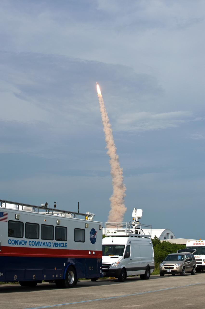 CAPE CANAVERAL, Fla. – Space shuttle Endeavour soars into the sky on the STS-127 mission from NASA Kennedy Space Center as convoy command and SCAPE vehicles are in position at the Shuttle Landing Facility in the event a return-to-landing-site is needed. Liftoff was on-time at 6:03 p.m. EDT. This was the sixth launch attempt for the STS-127 mission.  The launch was scrubbed on June 13 and June 17 when a hydrogen gas leak occurred during tanking due to a misaligned Ground Umbilical Carrier Plate.  The mission was postponed July 11, 12 and 13 due to weather conditions near the Shuttle Landing Facility at Kennedy that violated rules for launching, and lightning issues. Endeavour will deliver the Japanese Experiment Module's Exposed Facility and the Experiment Logistics Module-Exposed Section in the final of three flights dedicated to the assembly of the Japan Aerospace Exploration Agency's Kibo laboratory complex on the International Space Station.   Photo credit: NASA/Carl Winebarger