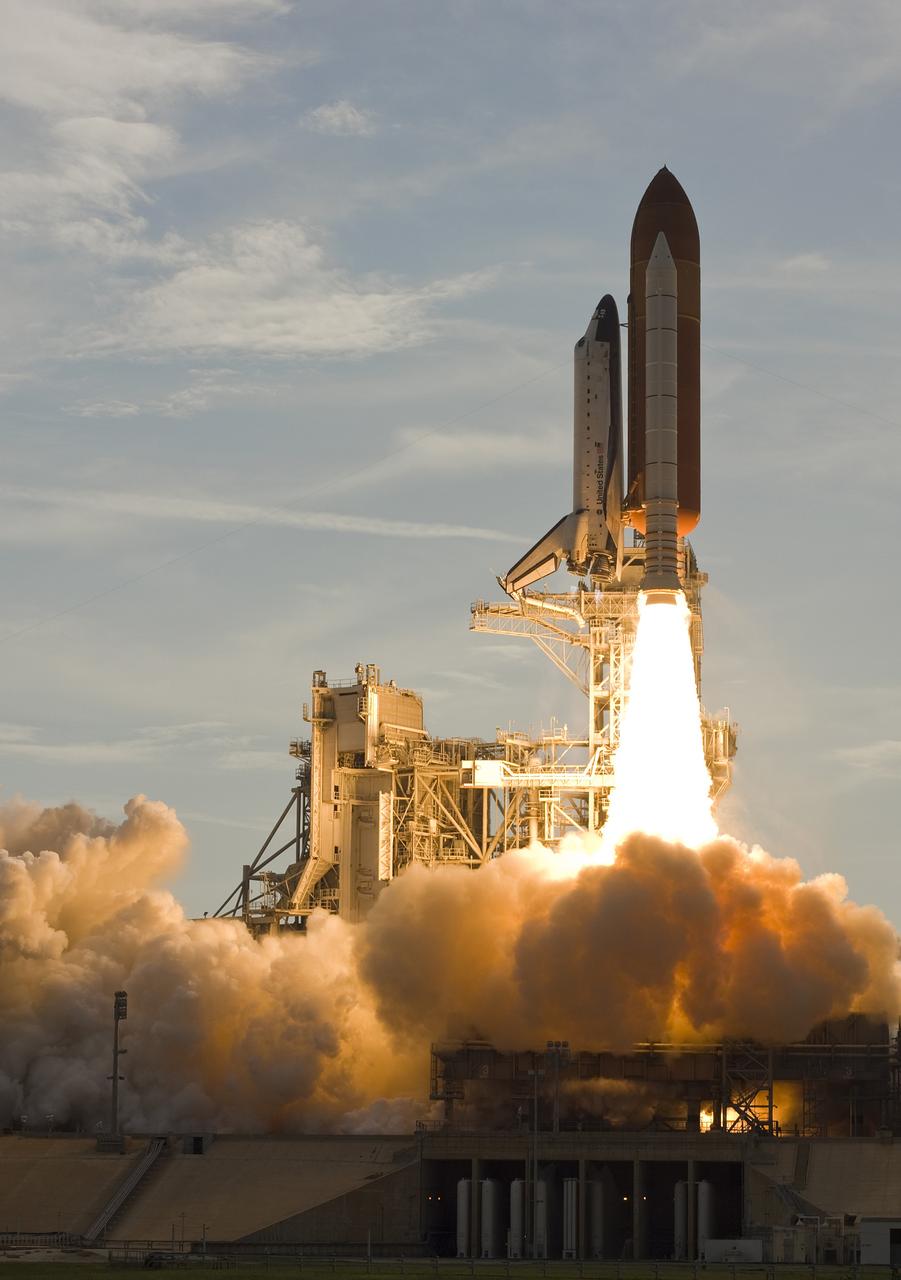 CAPE CANAVERAL, Fla. –  Space shuttle Endeavour clears the structures on NASA Kennedy Space Center's Launch Pad 39A as it majestically roars into the sky on the STS-127 mission. Liftoff was on-time at 6:03 p.m. EDT.   This was the sixth launch attempt for the STS-127 mission.  The launch was scrubbed on June 13 and June 17 when a hydrogen gas leak occurred during tanking due to a misaligned Ground Umbilical Carrier Plate.  The mission was postponed July 11, 12 and 13 due to weather conditions near the Shuttle Landing Facility at Kennedy that violated rules for launching, and lightning issues. Endeavour will deliver the Japanese Experiment Module's Exposed Facility and the Experiment Logistics Module-Exposed Section in the final of three flights dedicated to the assembly of the Japan Aerospace Exploration Agency's Kibo laboratory complex on the International Space Station.   Photo courtesy of Scott Andrews