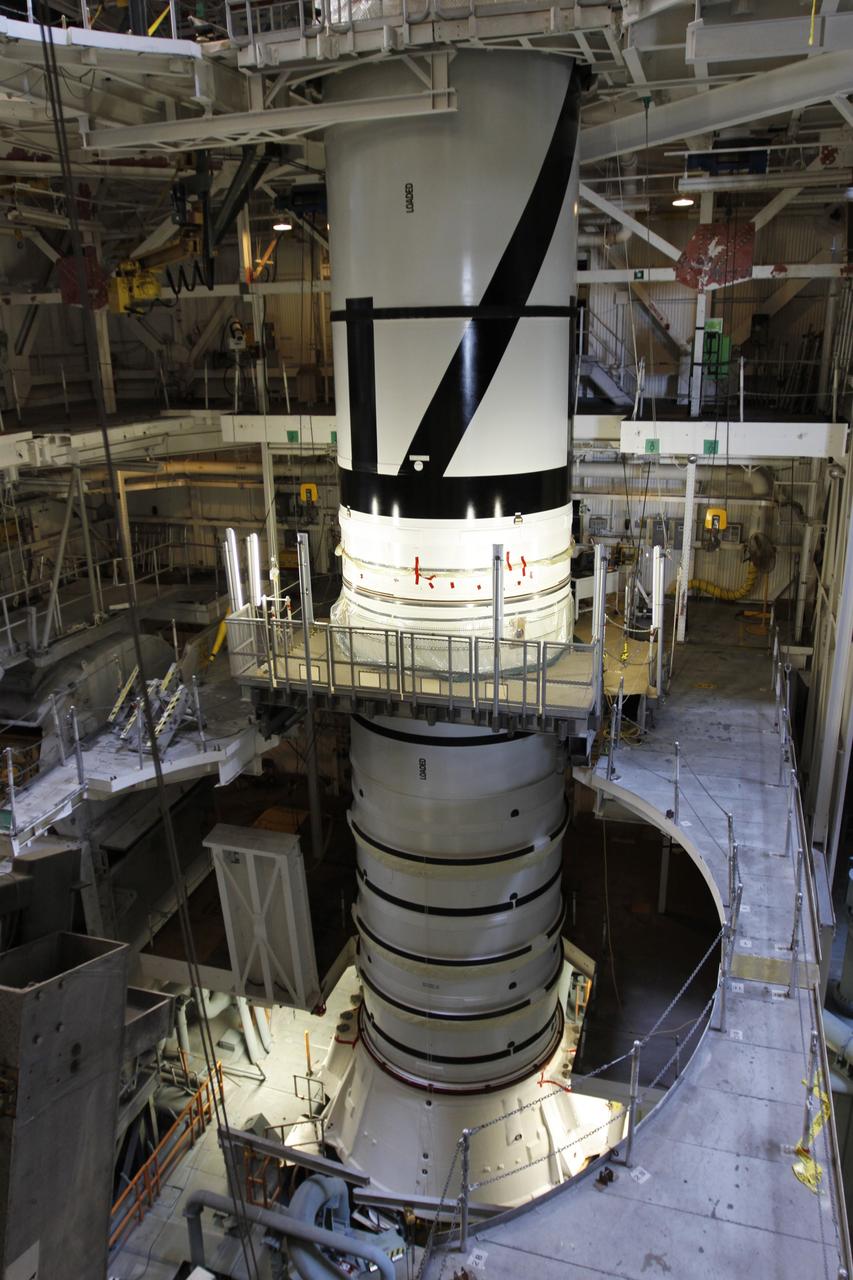 CAPE CANAVERAL, Fla. – In the Vehicle Assembly Building's High Bay 3 at NASA's Kennedy Space Center in Florida, the stacking of the Ares I-X segments is under way. Seen here are the aft center and the aft skirt segments. Part of the Constellation Program, the Ares I-X is the test vehicle for the Ares I, which is the essential core of a space transportation system that eventually will carry crewed missions back to the moon, on to Mars and out into the solar system . The Ares I-X flight test is targeted for no earlier than Aug. 30. Photo credit: NASA/Troy Cryder
