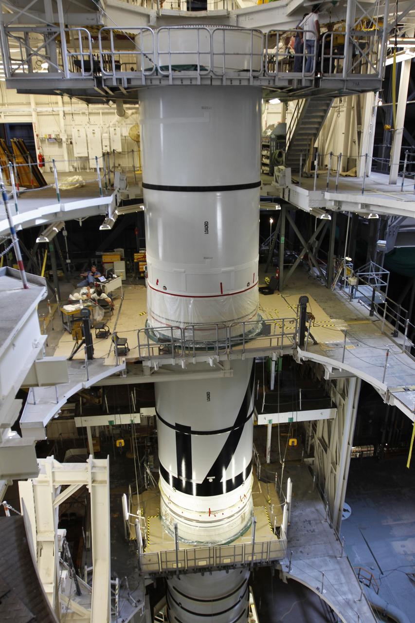 CAPE CANAVERAL, Fla. – In the Vehicle Assembly Building's High Bay 3 at NASA's Kennedy Space Center in Florida, the stacking of the Ares I-X segments is under way. Here, the forward center segment (top) is lowered onto the aft center and the aft skirt segments. Part of the Constellation Program, the Ares I-X is the test vehicle for the Ares I, which is the essential core of a space transportation system that eventually will carry crewed missions back to the moon, on to Mars and out into the solar system . The Ares I-X flight test is targeted for no earlier than Aug. 30. Photo credit: NASA/Troy Cryder