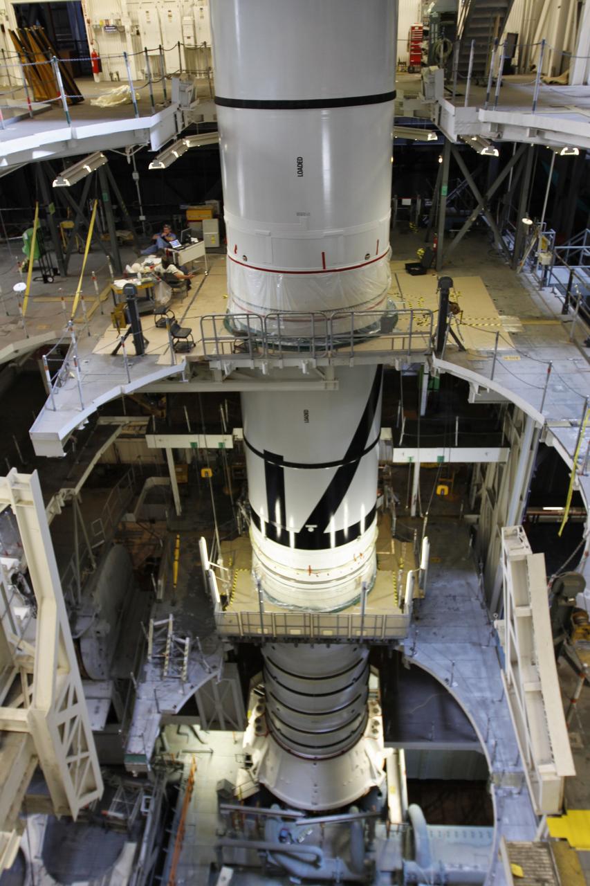 CAPE CANAVERAL, Fla. – In the Vehicle Assembly Building's High Bay 3 at NASA's Kennedy Space Center in Florida, the stacking of the Ares I-X segments is under way. Here, the forward center segment (top) is lowered onto the aft center and the aft skirt segments. Part of the Constellation Program, the Ares I-X is the test vehicle for the Ares I, which is the essential core of a space transportation system that eventually will carry crewed missions back to the moon, on to Mars and out into the solar system . The Ares I-X flight test is targeted for no earlier than Aug. 30. Photo credit: NASA/Troy Cryder