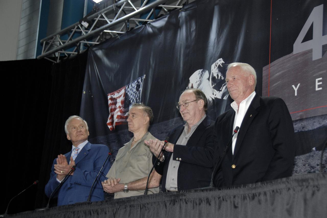 CAPE CANAVERAL, Fla. – At the Apollo/Saturn V Center at NASA's Kennedy Space Center in Florida, Apollo astronauts Buzz Aldrin, Walt Cunningham, Edgar Mitchell and Al Worden applaud during the introduction of Charlie Duke at NASA's 40th Anniversary of Apollo Celebration of the July 1969 launch and landing on the moon. Eight Apollo astronauts participated in the ceremony. Photo credit: NASA/Kim Shiflett