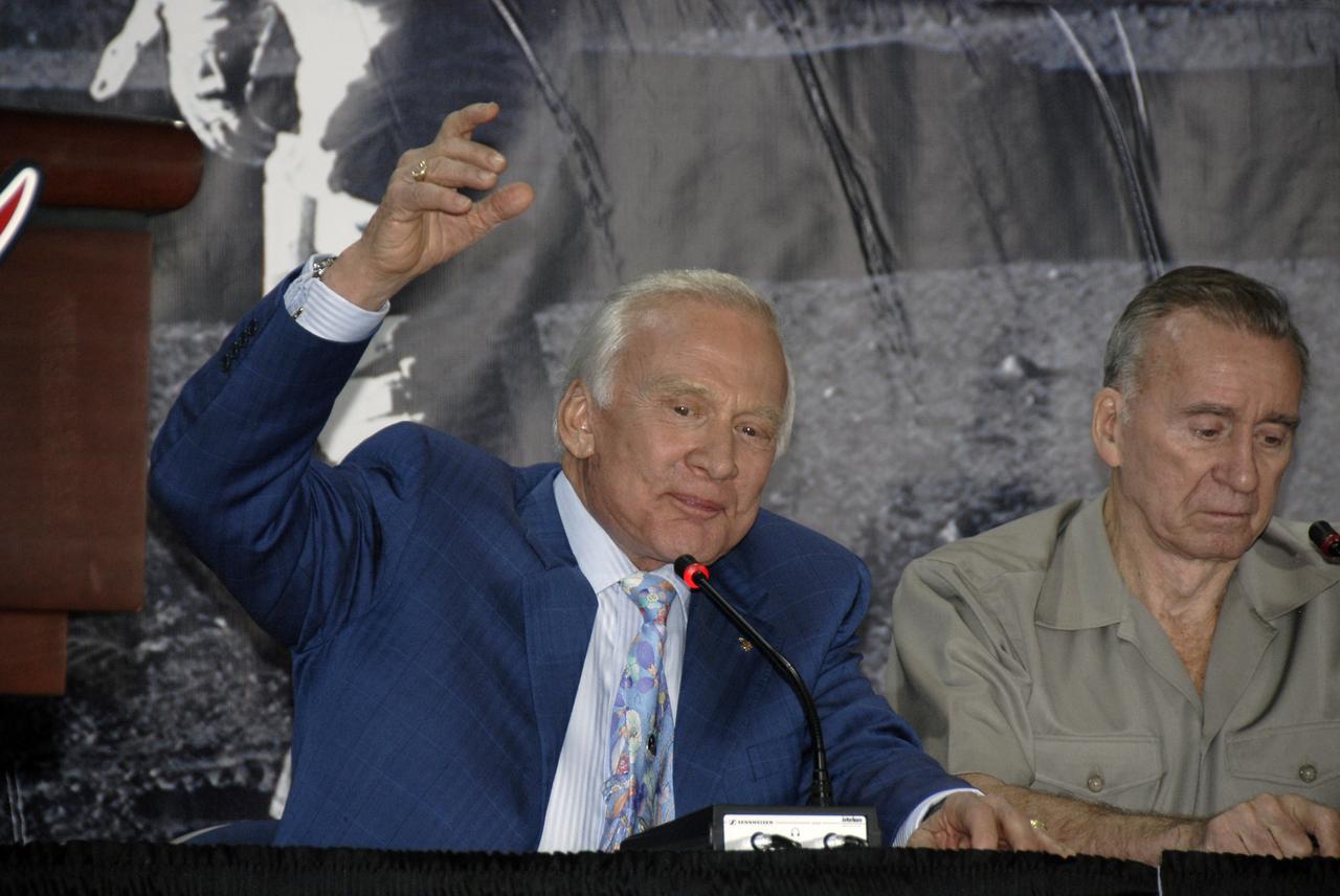 CAPE CANAVERAL, Fla. –  At the Apollo/Saturn V Center at NASA's Kennedy Space Center in Florida, Apollo astronaut Buzz Aldrin comments on his experiences as one of the first moon walkers, on the Apollo 11 mission in July 1969.  At right is astronaut Walt Cunningham. Aldrin, Cunningham and other Apollo astronauts participated in NASA's 40th Anniversary of Apollo Celebration. Photo credit: NASA/Kim Shiflett