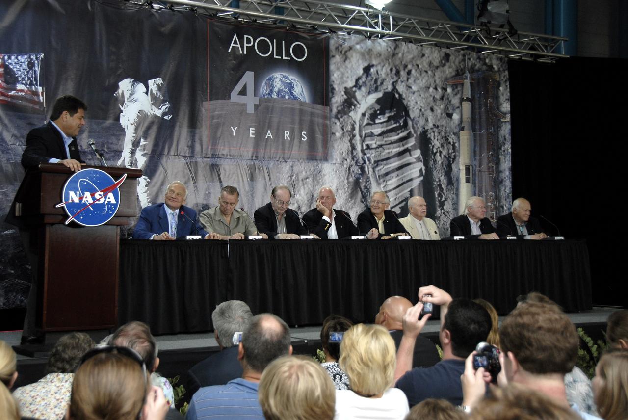 CAPE CANAVERAL, Fla. –  CNN correspondent John Zarella, left, moderates NASA's 40th Anniversary of Apollo Celebration of the July 1969 launch and landing on the moon. The ceremony, held in the Apollo/Saturn V Center at NASA's Kennedy Space Center in Florida featured Apollo astronauts (at the dais) Buzz Aldrin, Walt Cunningham, Edgar Mitchell, Al Worden, Charlie Duke, Vance Brand, Gerald Carr and Bruce McCandless.  Photo credit: NASA/Kim Shiflett