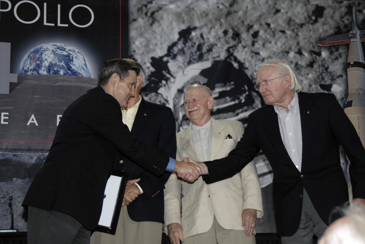 CAPE CANAVERAL, Fla. – Closing NASA's 40th Anniversary of Apollo Celebration at the Apollo/Saturn V Center at NASA's Kennedy Space Center in Florida, Center Director Bob Cabana thanks the Apollo astronauts who participated.  Seen here are Charlie Duke (behind Cabana), Vance Brand and Gerald Carr. The celebration honored the July 1969 launch and landing on the moon.  Photo credit: NASA/Kim Shiflett