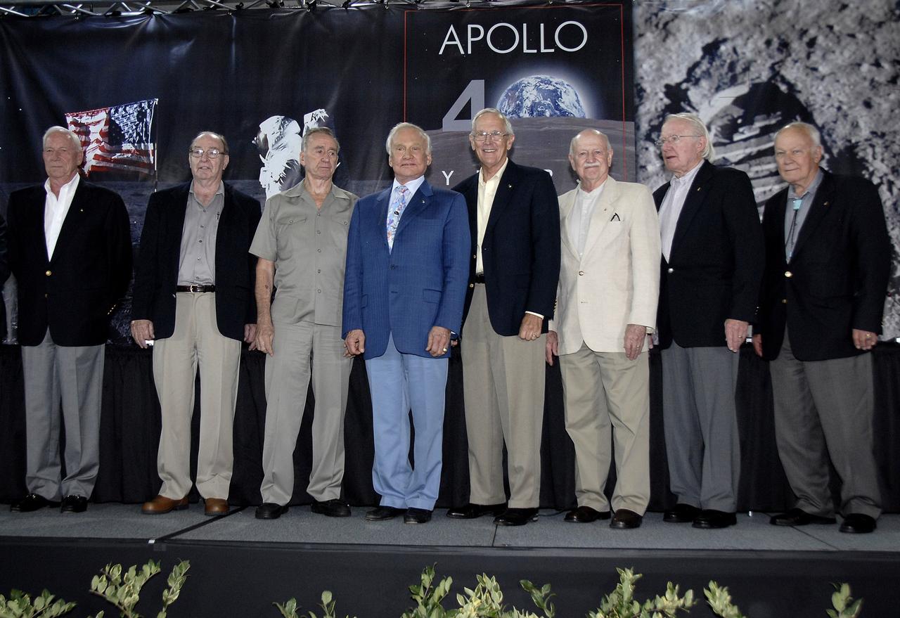 CAPE CANAVERAL, Fla. – Apollo astronauts who participated in NASA's 40th Anniversary of Apollo Celebration at NASA Kennedy Space Center's Apollo/Saturn V Center pose for photographers and guests.  From left are Al Worden, Edgar Mitchell, Walt Cunningham, Buzz Aldrin, Charlie Duke, Vance Brand, Gerald Carr and Bruce McCandless. The celebration honored the July 1969 launch and landing on the moon.  Photo credit: NASA/Kim Shiflett