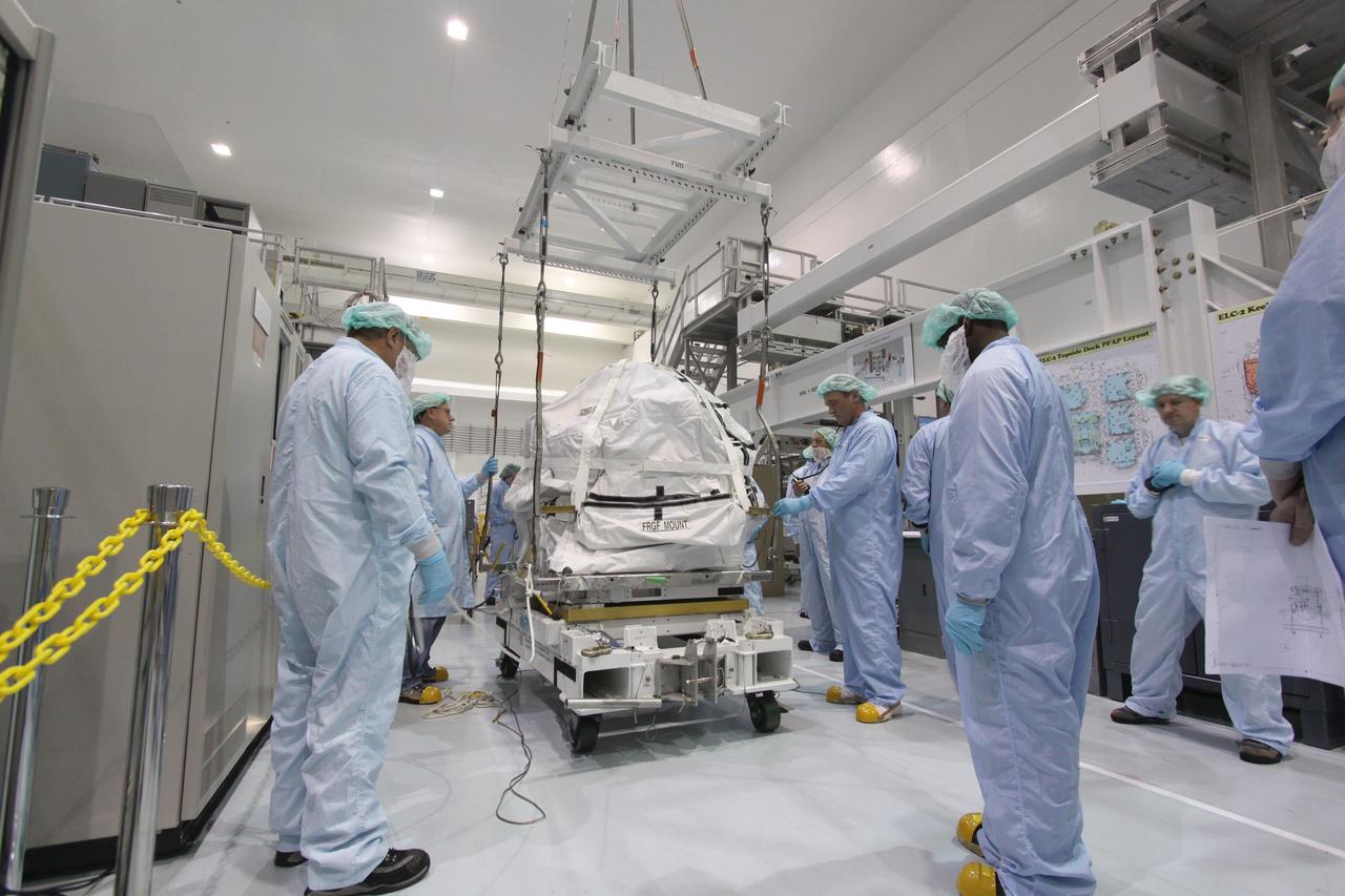 CAPE CANAVERAL, Fla. – In the Space Station Processing Facility at NASA's Kennedy Space Center in Florida, technicians get ready to move the control moment gyroscope, or CMG, to an EXPRESS Logistics Carrier. The carrier is part of the STS-129 payload on space shuttle Atlantis, which will deliver to the International Space Station two spare gyroscopes, two nitrogen tank assemblies, two pump modules, an ammonia tank assembly and a spare latching end effector for the station's robotic arm.  STS-129 is targeted to launch Nov. 12 .  Photo credit: NASA/Jack Pfaller