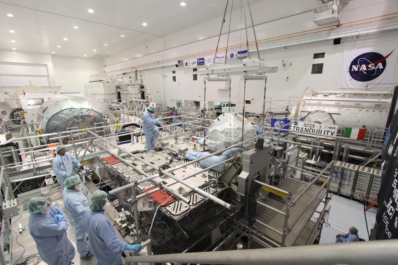 CAPE CANAVERAL, Fla. – In the Space Station Processing Facility at NASA's Kennedy Space Center in Florida,  technicians check the position of the control moment gyroscope after being placed on an EXPRESS Logistics Carrier. The carrier is part of the STS-129 payload on space shuttle Atlantis, which will deliver to the International Space Station two spare gyroscopes, two nitrogen tank assemblies, two pump modules, an ammonia tank assembly and a spare latching end effector for the station's robotic arm.  STS-129 is targeted to launch Nov. 12 .  Photo credit: NASA/Jack Pfaller