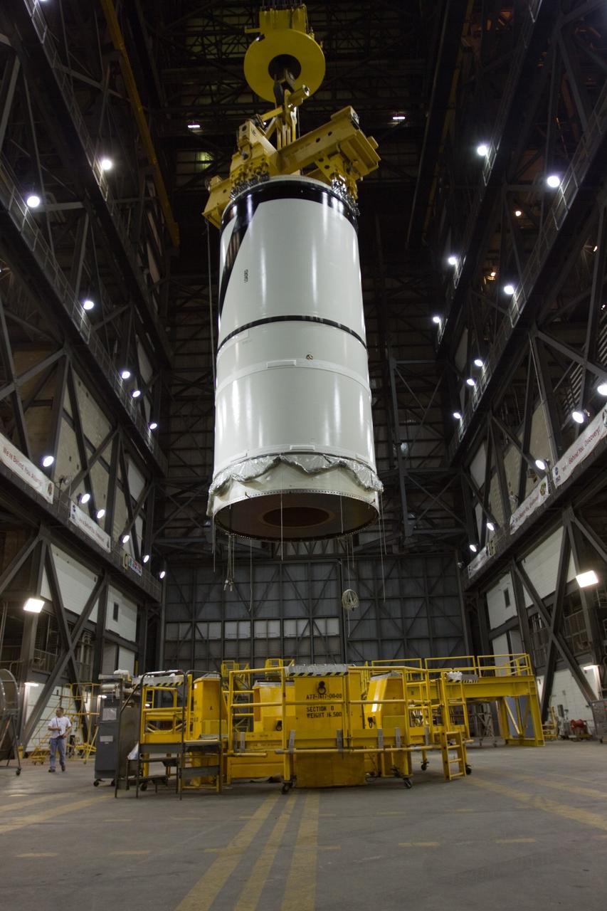 CAPE CANAVERAL, Fla. – In the transfer aisle of NASA Kennedy Space Center's Vehicle Assembly Building, the Ares I-X forward segment is lifted. It will be moved into High Bay 3 for stacking with the forward center, aft center and the aft skirt segments. Part of the Constellation Program, the Ares I-X is the test vehicle for the Ares I, which is the essential core of a space transportation system that eventually will carry crewed missions back to the moon, on to Mars and out into the solar system . The Ares I-X flight test is targeted for no earlier than Aug. 30. Photo credit: NASA/Troy Cryder