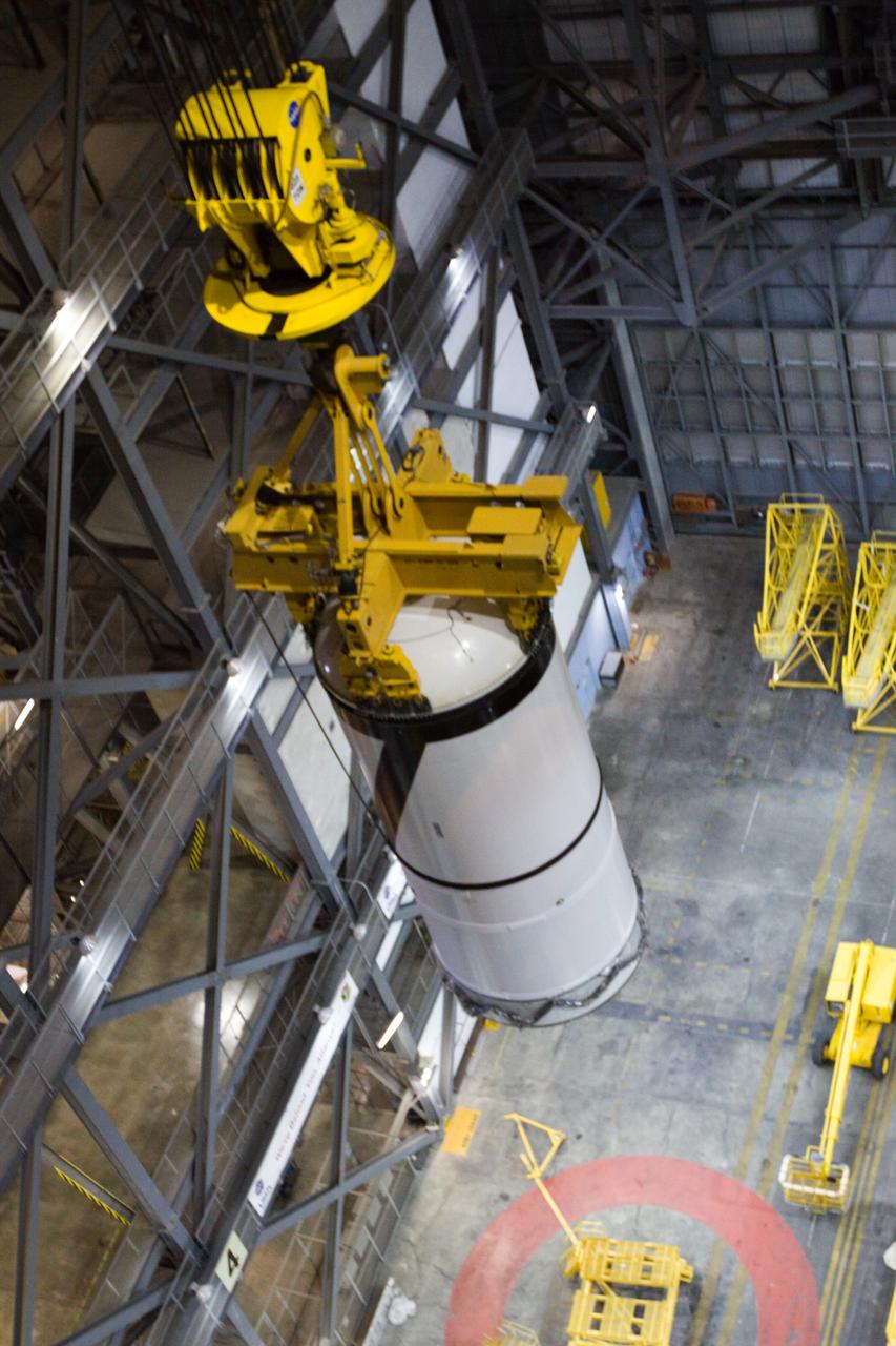 CAPE CANAVERAL, Fla. – In the transfer aisle of NASA Kennedy Space Center's Vehicle Assembly Building, the Ares I-X forward segment is lifted into the upper levels. It will be moved into High Bay 3 for stacking with the forward center, aft center and the aft skirt segments. Part of the Constellation Program, the Ares I-X is the test vehicle for the Ares I, which is the essential core of a space transportation system that eventually will carry crewed missions back to the moon, on to Mars and out into the solar system . The Ares I-X flight test is targeted for no earlier than Aug. 30. Photo credit: NASA/Troy Cryder