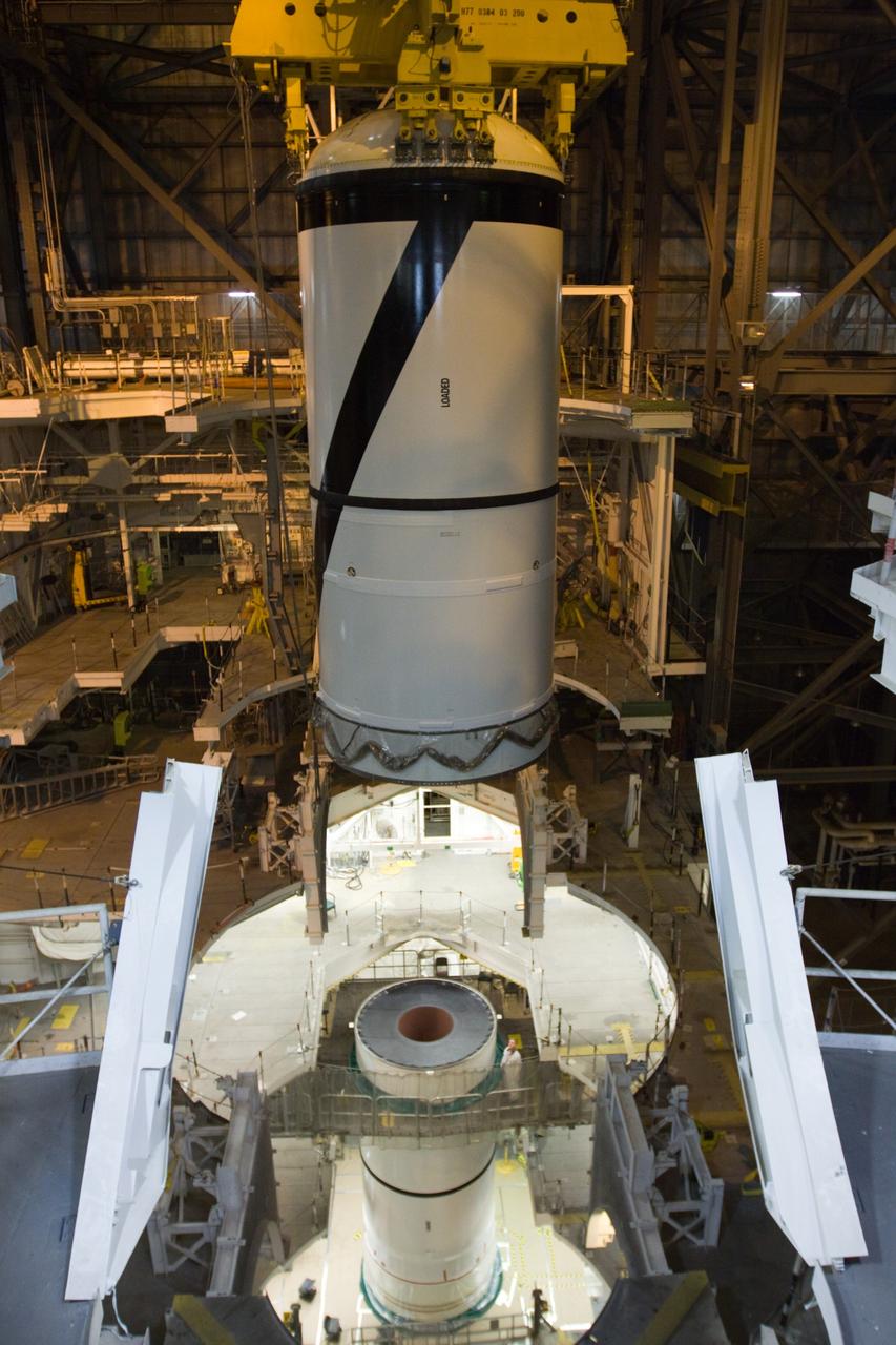 CAPE CANAVERAL, Fla. – In the High Bay 3 of NASA Kennedy Space Center's Vehicle Assembly Building, the Ares I-X forward segment is lowered toward the forward center for mating. The forward center is already mated with the aft center and the aft skirt segments below. Part of the Constellation Program, the Ares I-X is the test vehicle for the Ares I, which is the essential core of a space transportation system that eventually will carry crewed missions back to the moon, on to Mars and out into the solar system . The Ares I-X flight test is targeted for no earlier than Aug. 30. Photo credit: NASA/Troy Cryder