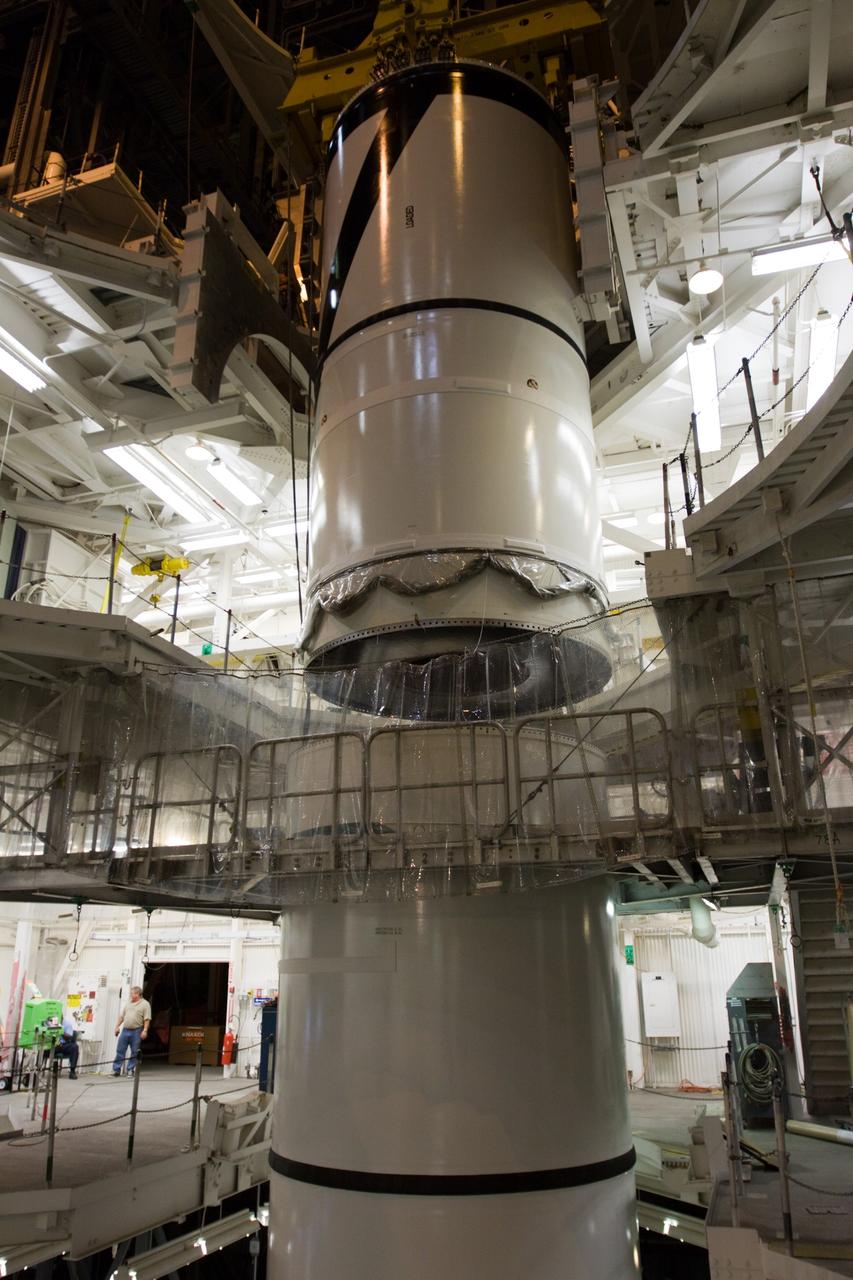 CAPE CANAVERAL, Fla. – In the High Bay 3 of NASA Kennedy Space Center's Vehicle Assembly Building, the Ares I-X forward segment is lowered onto the forward center for mating. The forward center is already mated with the aft center and the aft skirt segments below. Part of the Constellation Program, the Ares I-X is the test vehicle for the Ares I, which is the essential core of a space transportation system that eventually will carry crewed missions back to the moon, on to Mars and out into the solar system . The Ares I-X flight test is targeted for no earlier than Aug. 30. Photo credit: NASA/Troy Cryder