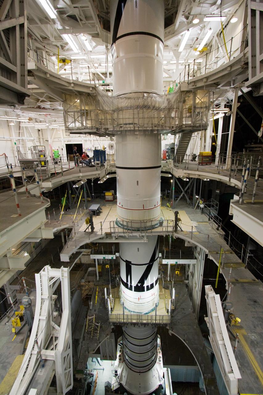 CAPE CANAVERAL, Fla. – In the Vehicle Assembly Building's High Bay 3 at NASA's Kennedy Space Center in Florida, workers secure the attachment, or mating, of the Ares I-X forward segment to the forward center segment atop the aft assembly (aft segment and aft skirt). Part of the Constellation Program, the Ares I-X is the test vehicle for the Ares I, which is the essential core of a space transportation system that eventually will carry crewed missions back to the moon, on to Mars and out into the solar system . The Ares I-X flight test is targeted for no earlier than Aug. 30. Photo credit: NASA/Jack Pfaller